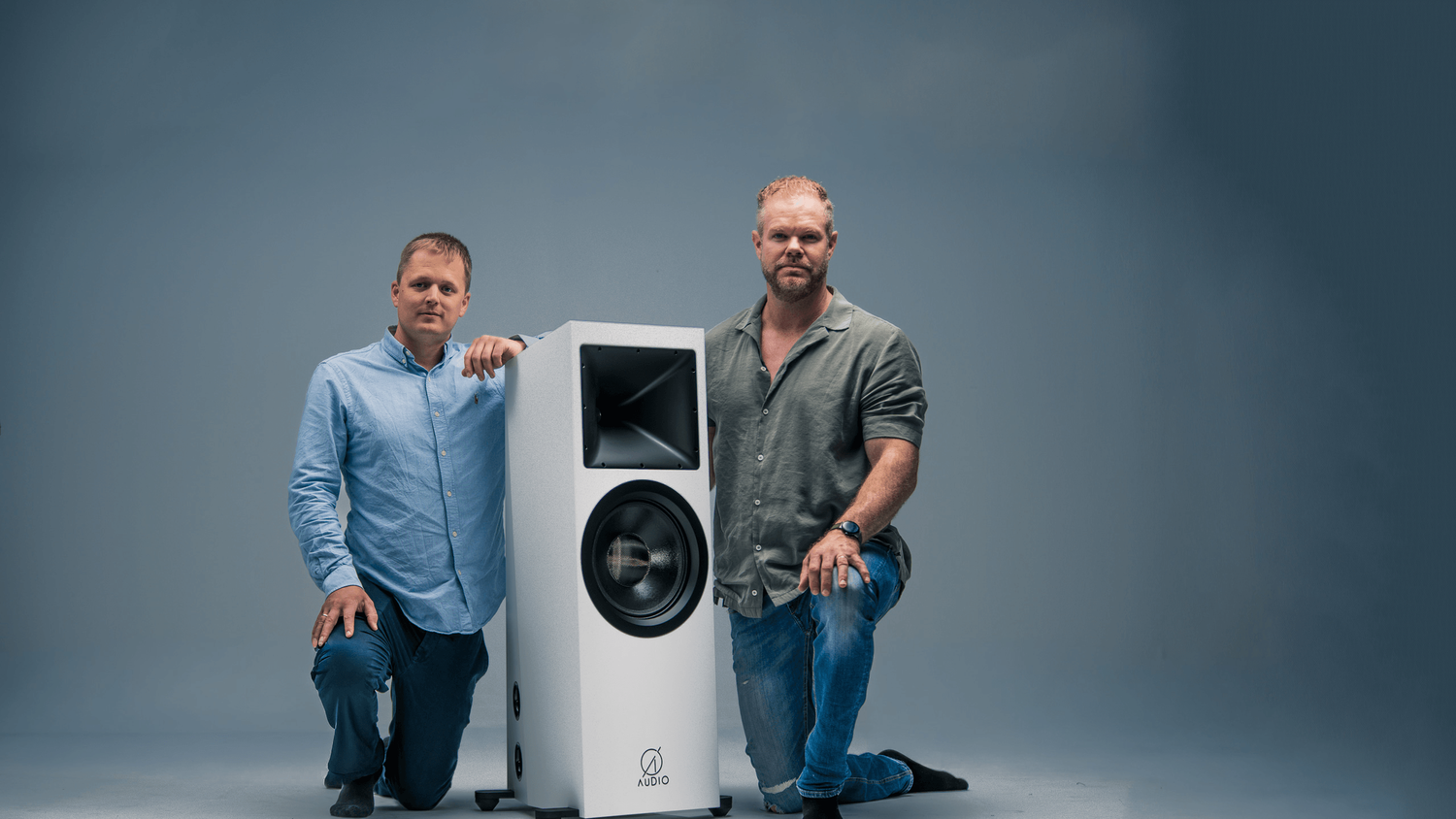 Ø Audio’s co-founders beside a loudspeaker