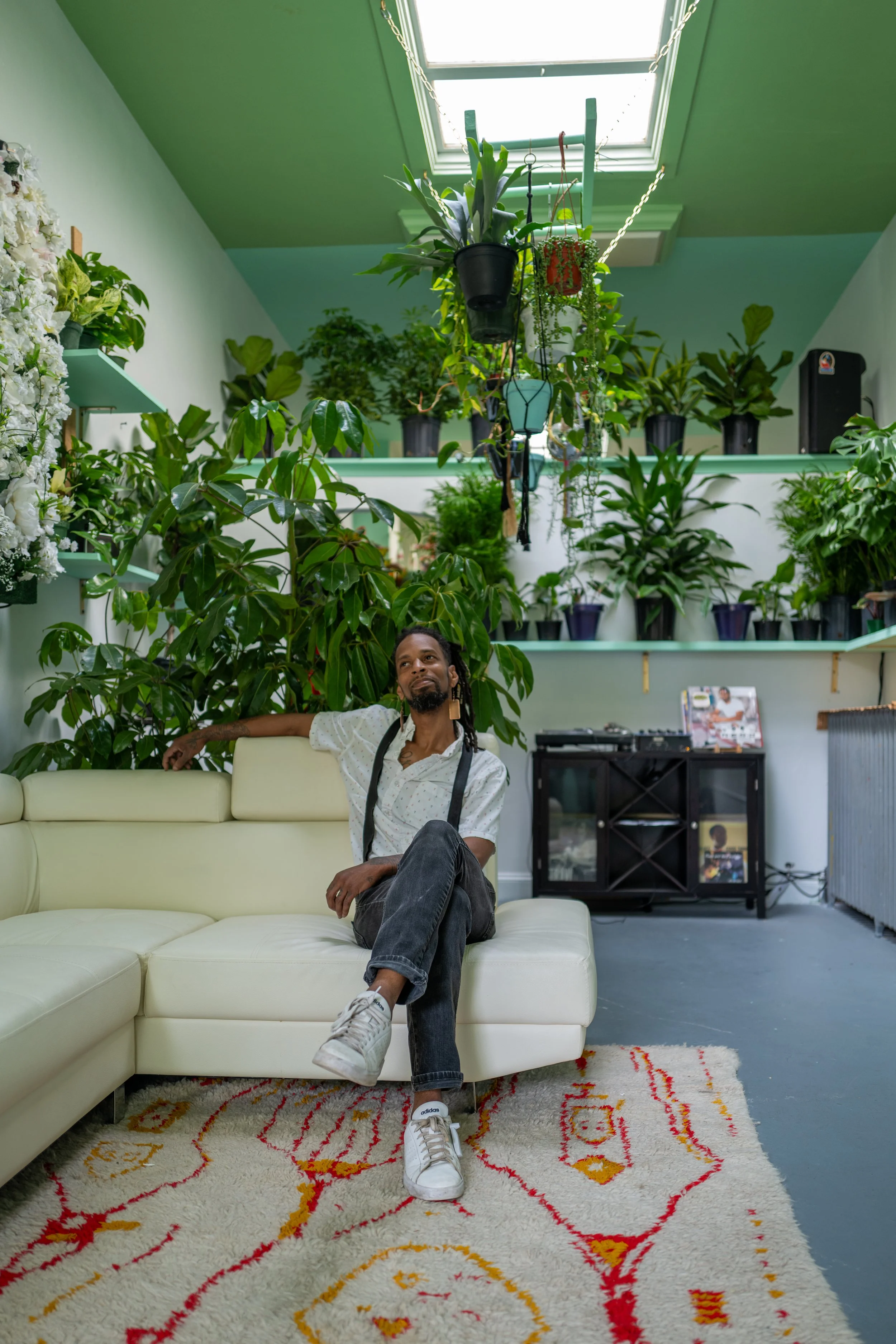Welcome 2 The Jungle owner gazing at plants in the shop