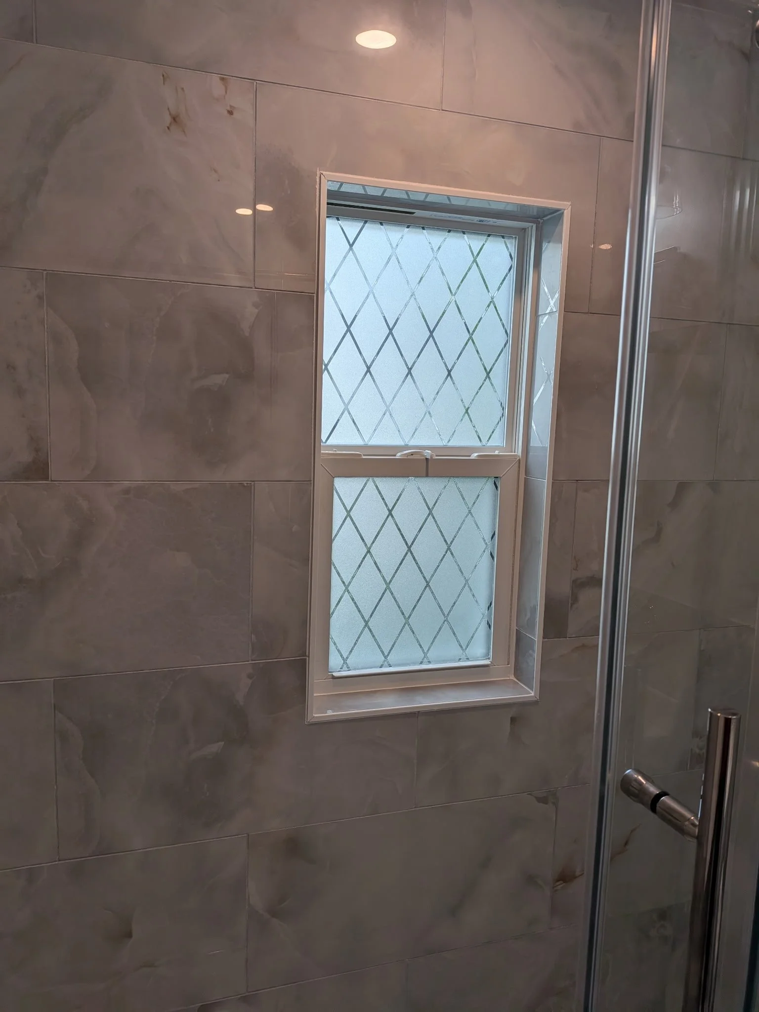 New window inside the shower with privacy glass.