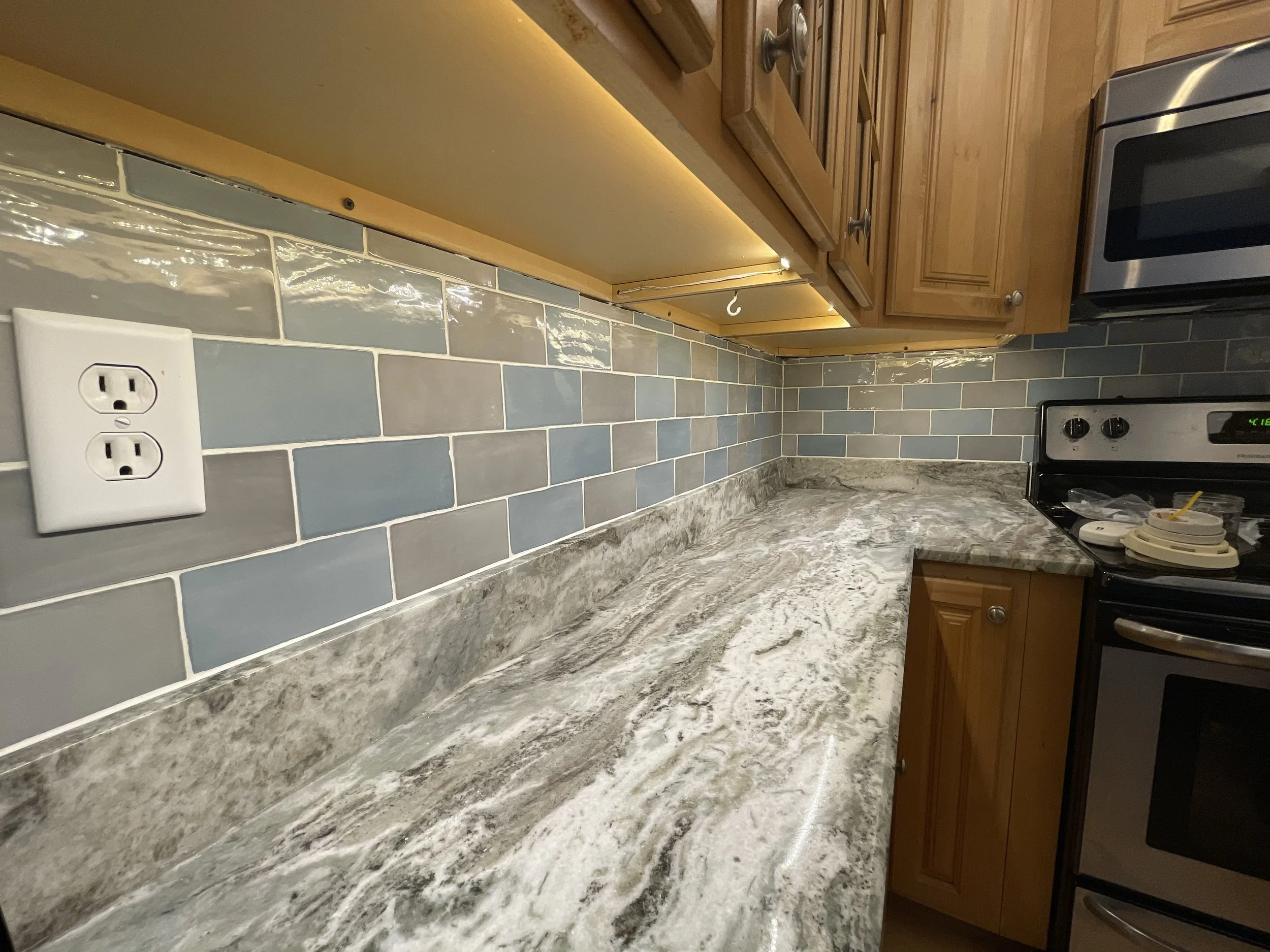 Glass subway tile backsplash.