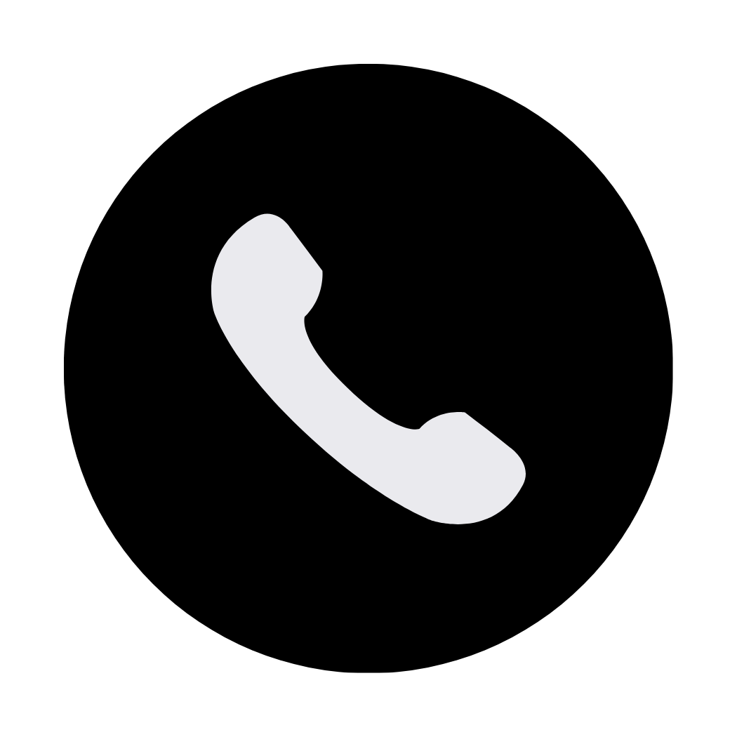 Icon of a white telephone handset on a black circular background.