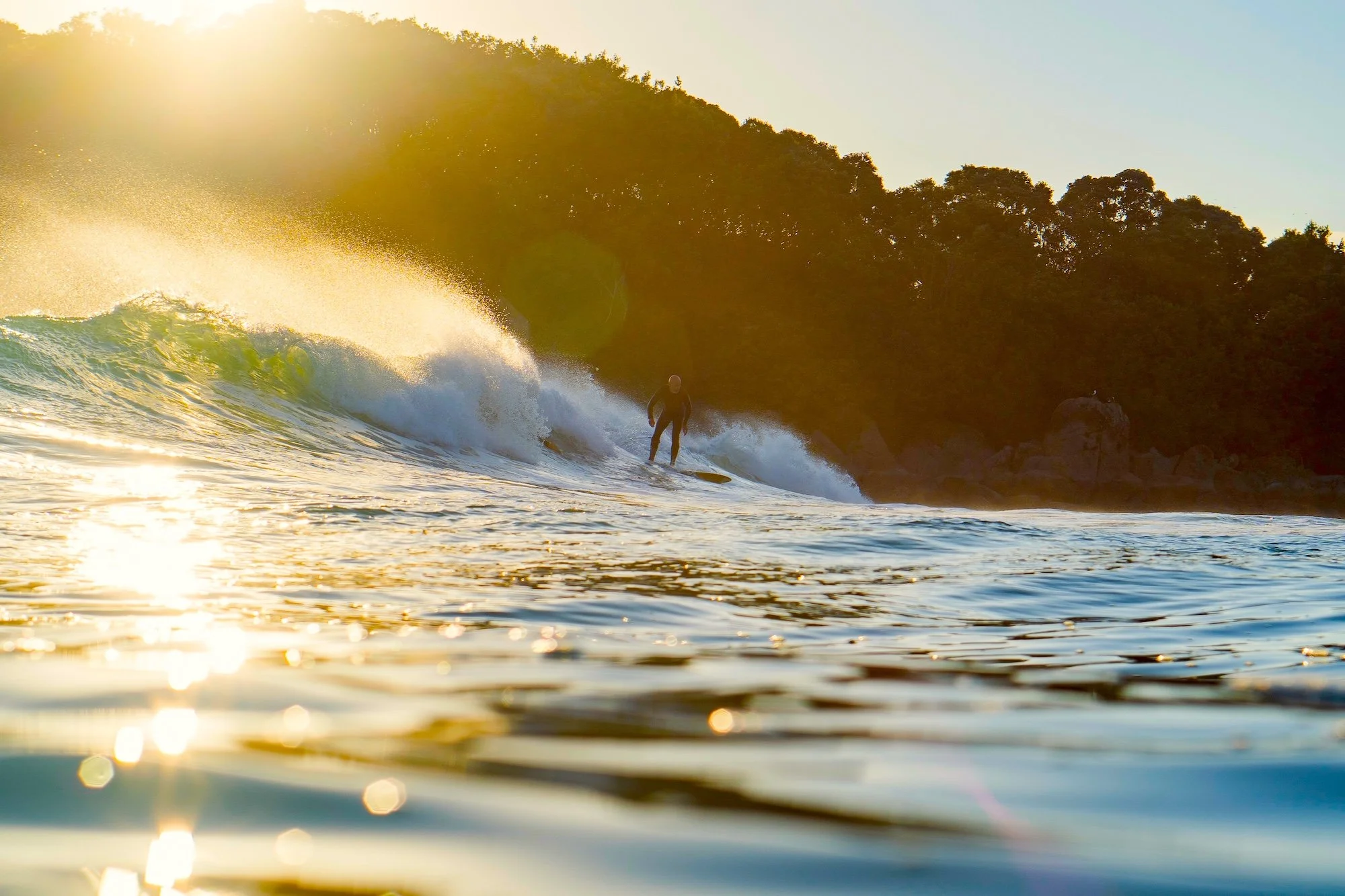 Portrait photographer Tony Aubrey surfing at Mount Maunganui, New Zealand.