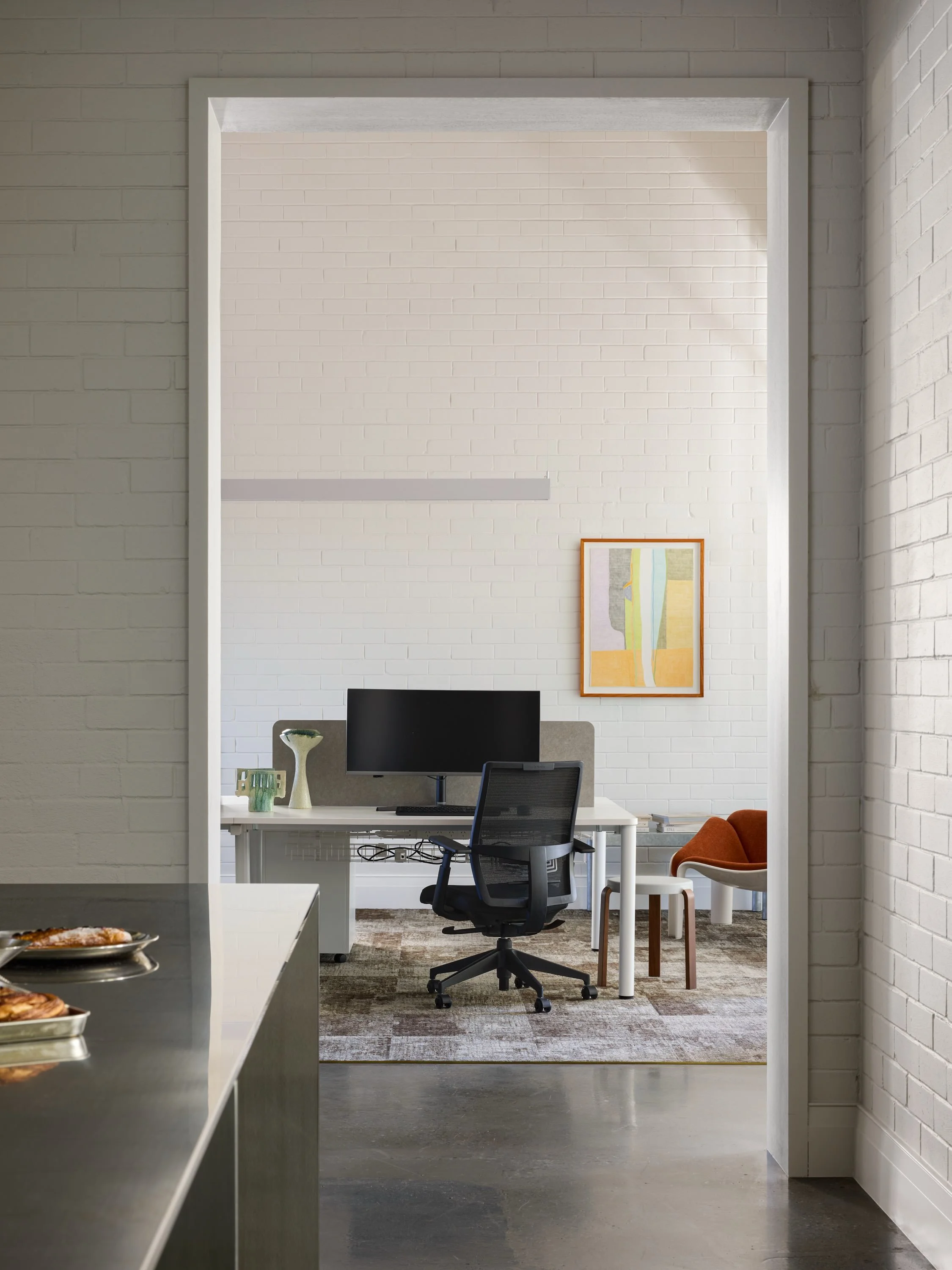 Chelsea Village, Nedlands. 

We were engaged by Evolution Custom Homes to design their new office, with the challenge of merging two tenancies into one space that could flow and function as a working environment while remaining hospitable and invitin