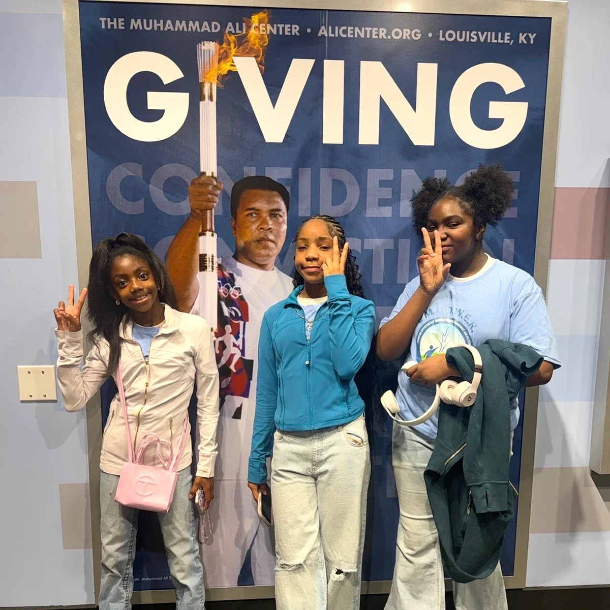 Photo of students in front of giving sign