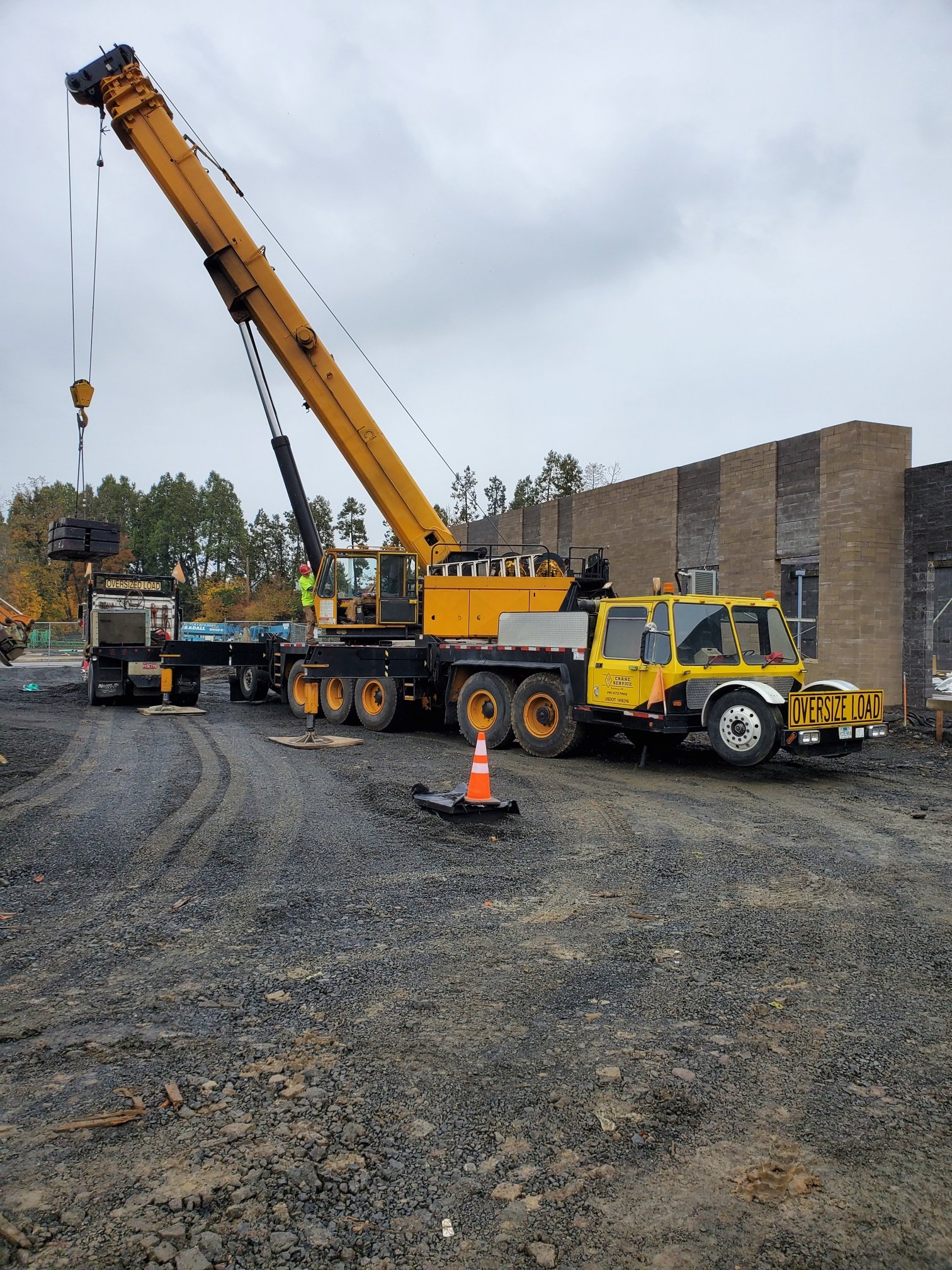Commercial building construction with crane and steel erection equipment