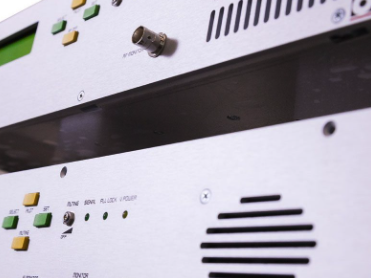 Close-up of a white electronic device with various buttons and vents.