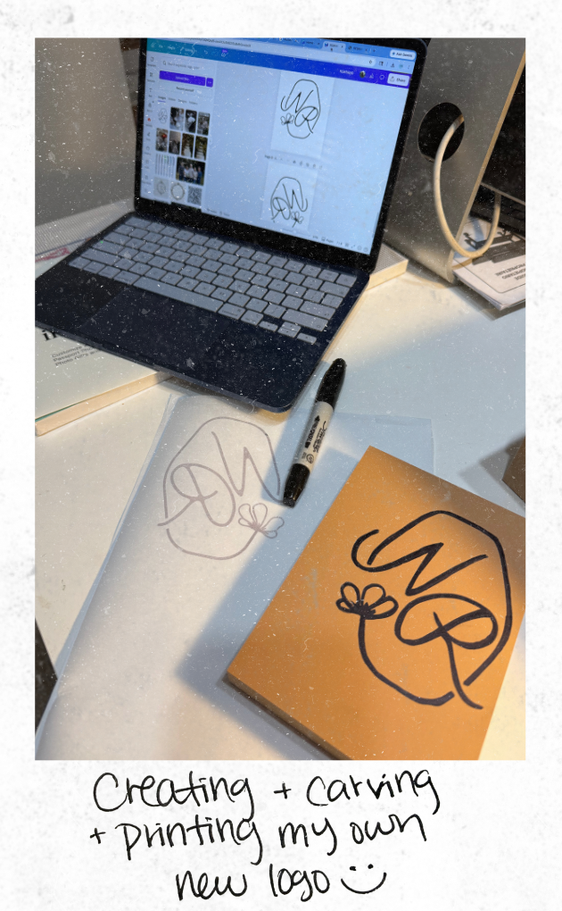 A workspace with a laptop showing a logo design program, a black marker, printed logo drafts, and a new logo on a yellow card. Handwritten text at the bottom reads, 'Creating + carving + printing my own new logo :).'