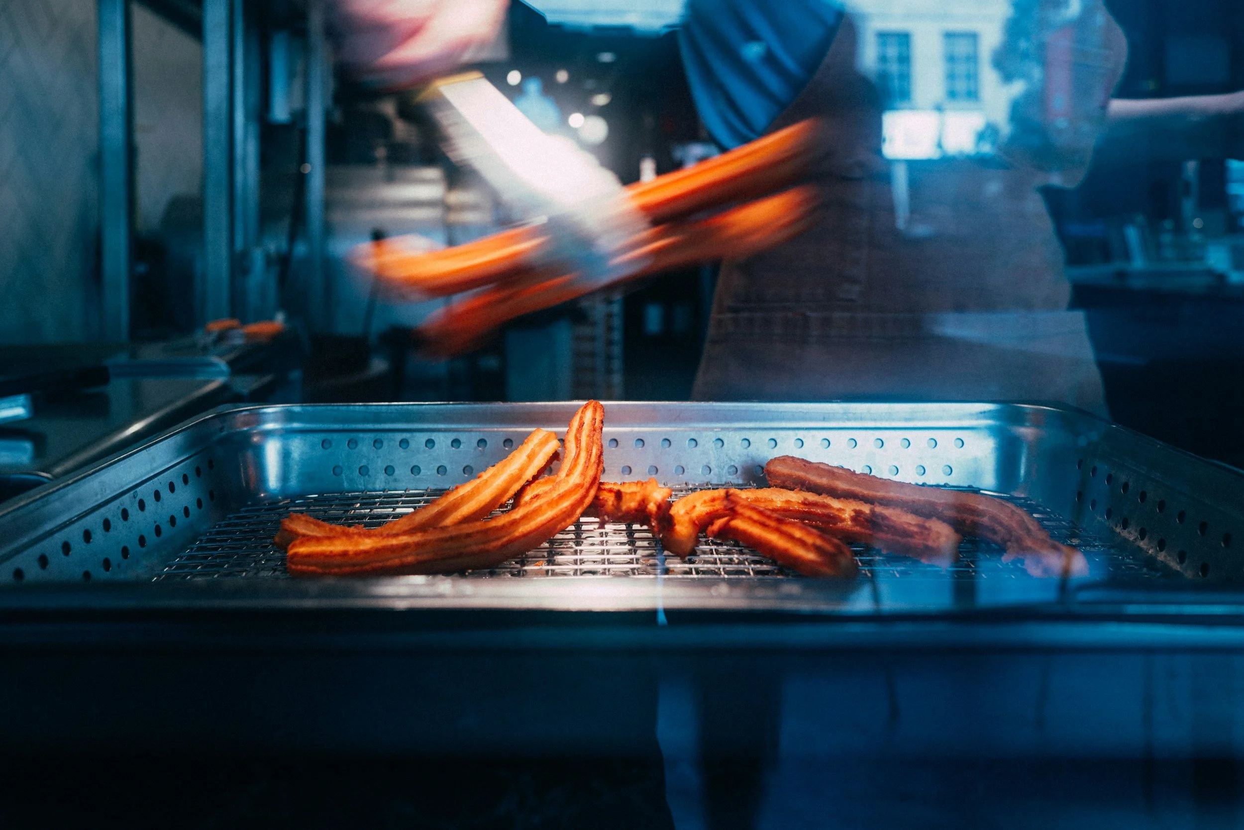 hot and fresh churro made by a local street food vendor
