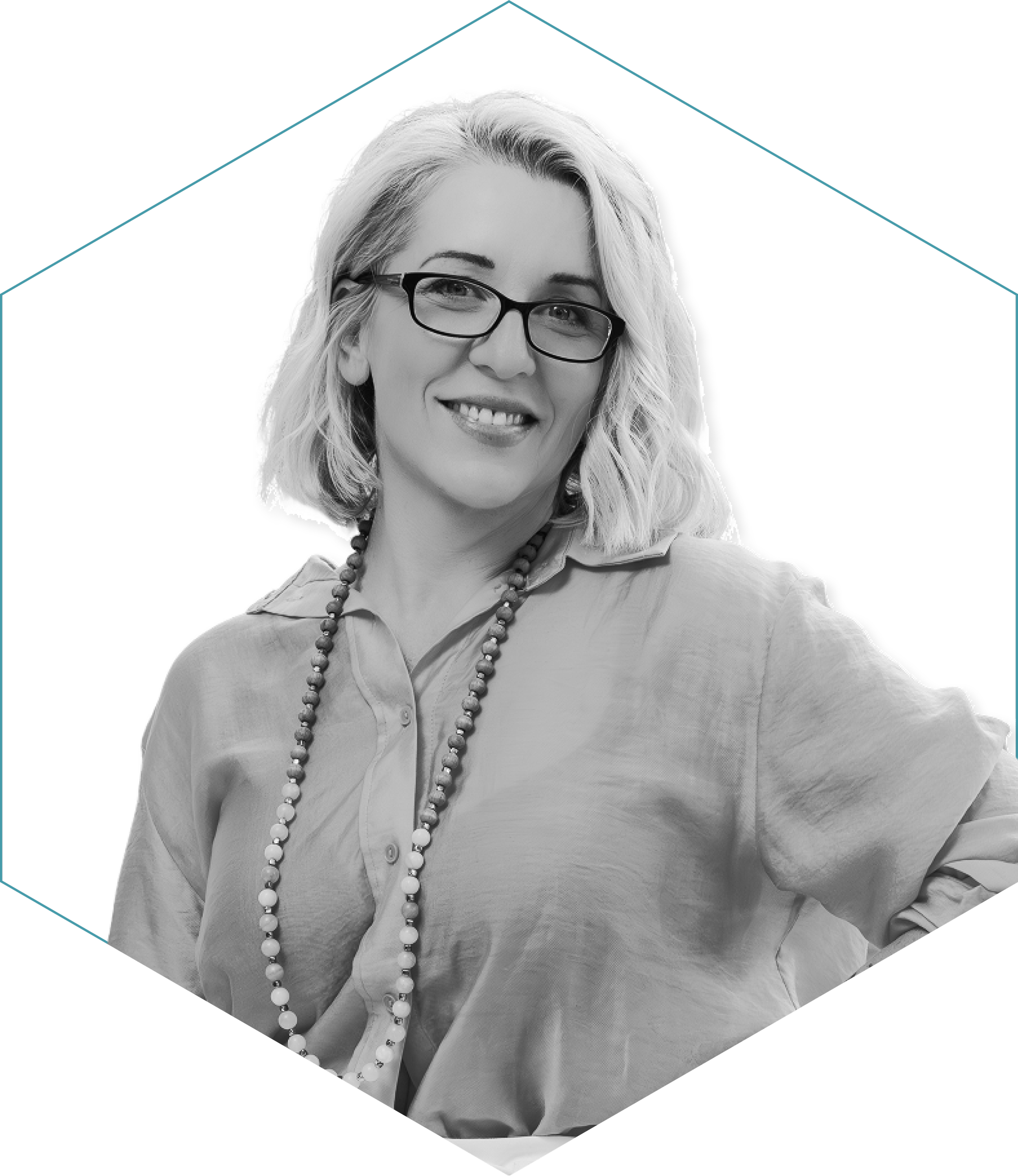 Black and white portrait of a woman with glasses, smiling, wearing a beaded necklace and a button-up shirt, in a photo with a digitally altered artistic background.