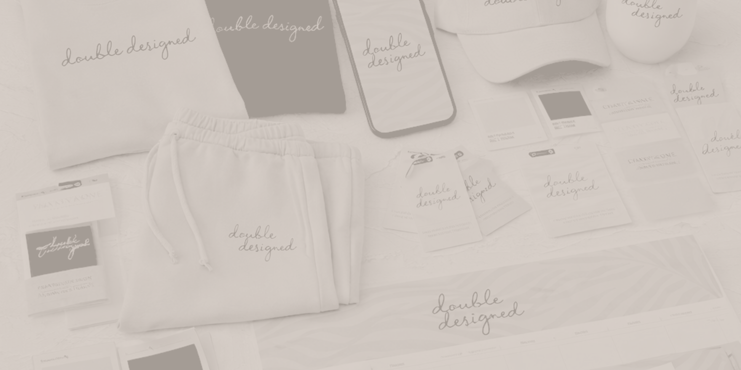 Multiple white and gray coasters, a pack of white pants, and various cards and tags with the words "double designed" are spread out on a light-colored surface.