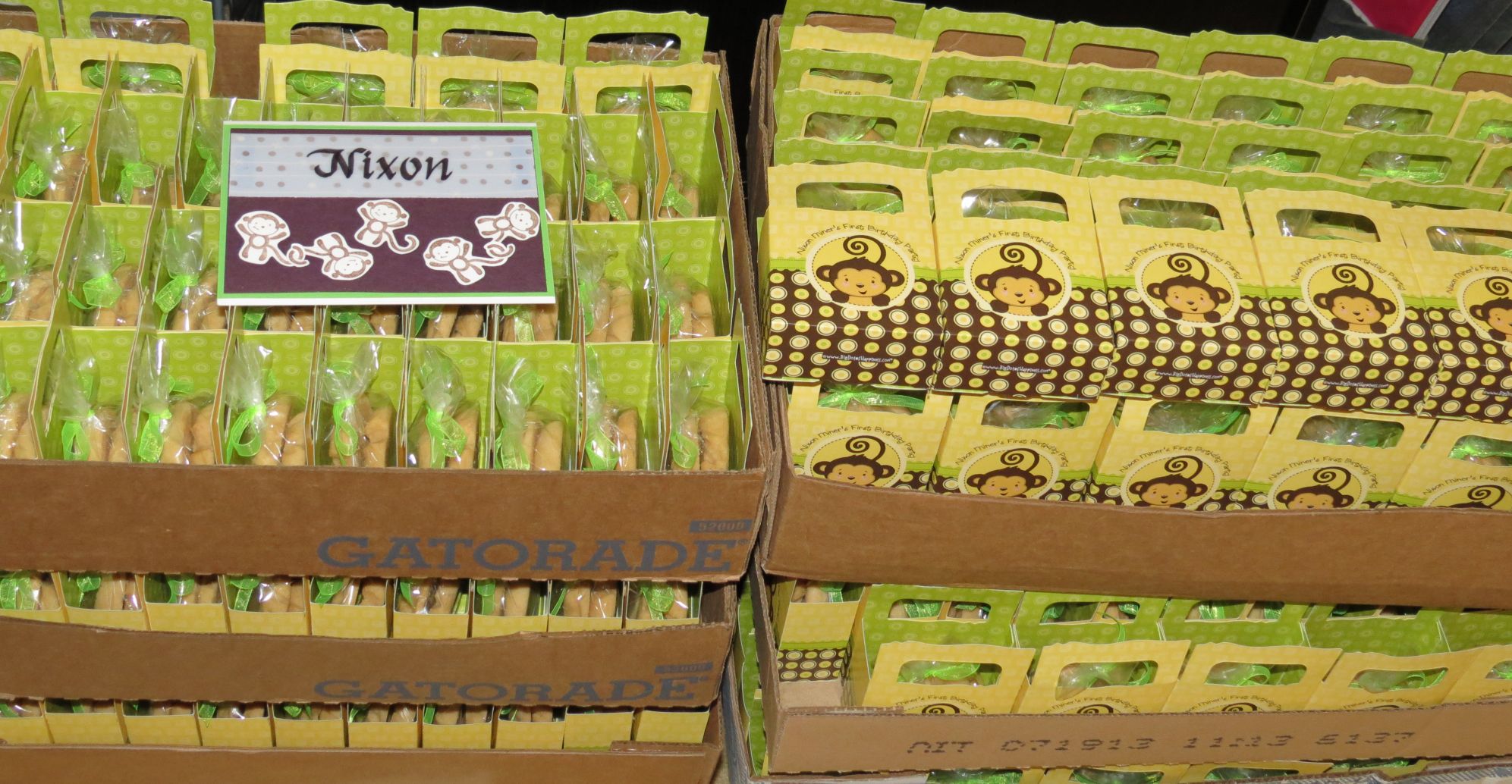 Display of boxed cookies with monkey and birthday theme packaging in a grocery store.