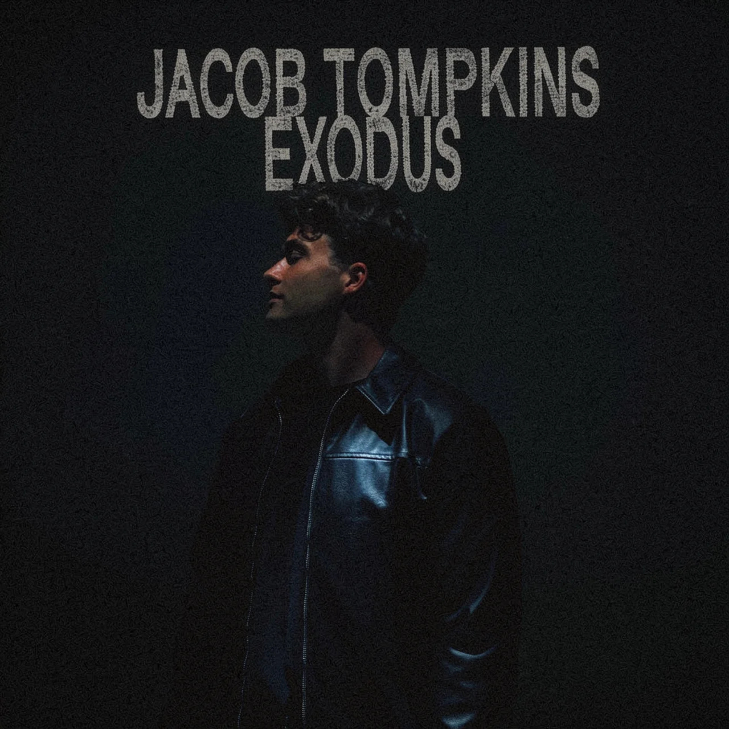 Album cover for Jacob Tompkins' "Exodus," featuring a side profile of a man with short black hair wearing a black leather jacket against a dark background with gray text.
