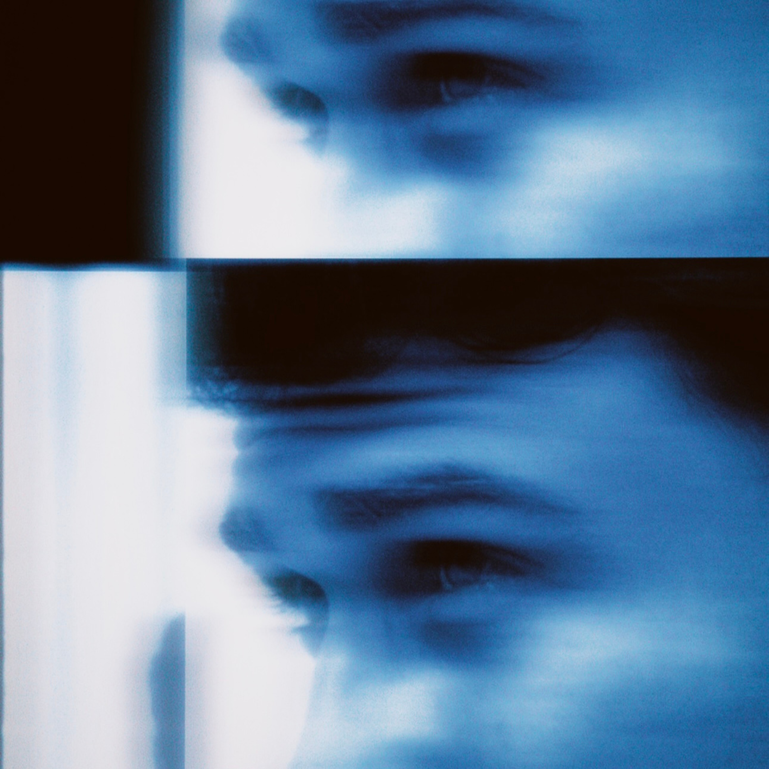 Close-up of a person's face, focusing on the eyes and nose, with a blue overlay and blurry background.