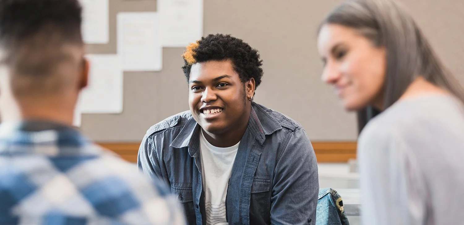Students of Directions to Diploma having a discussion in a classroom (hero image)