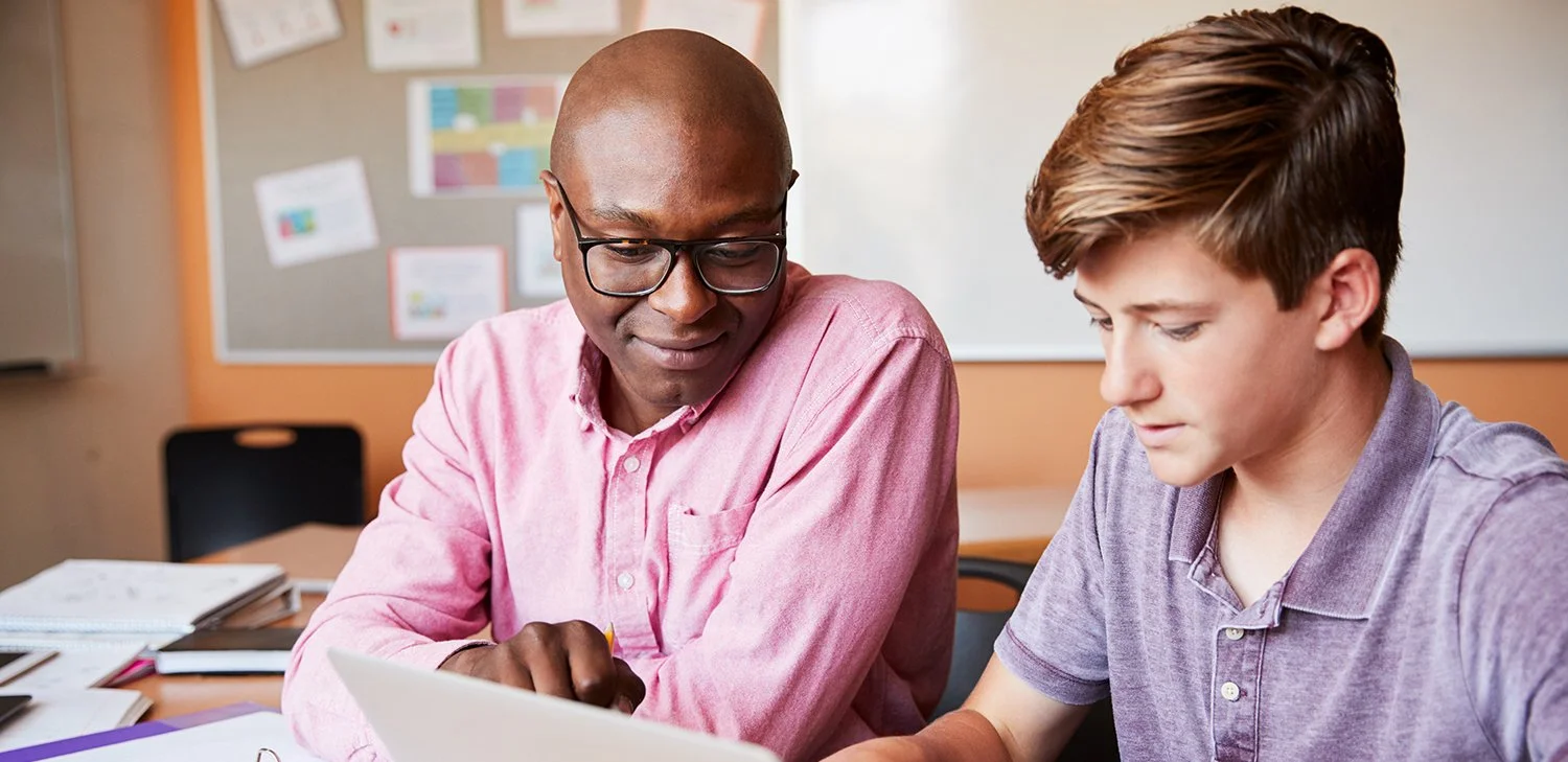 Adult Educator interacting with High School Student