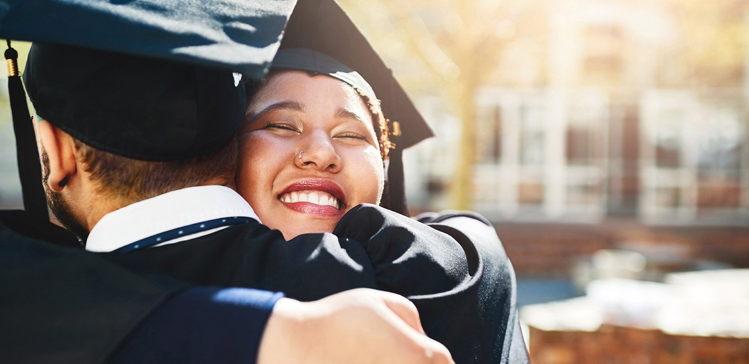 Directions to Diploma student graduates hugging (hero image)