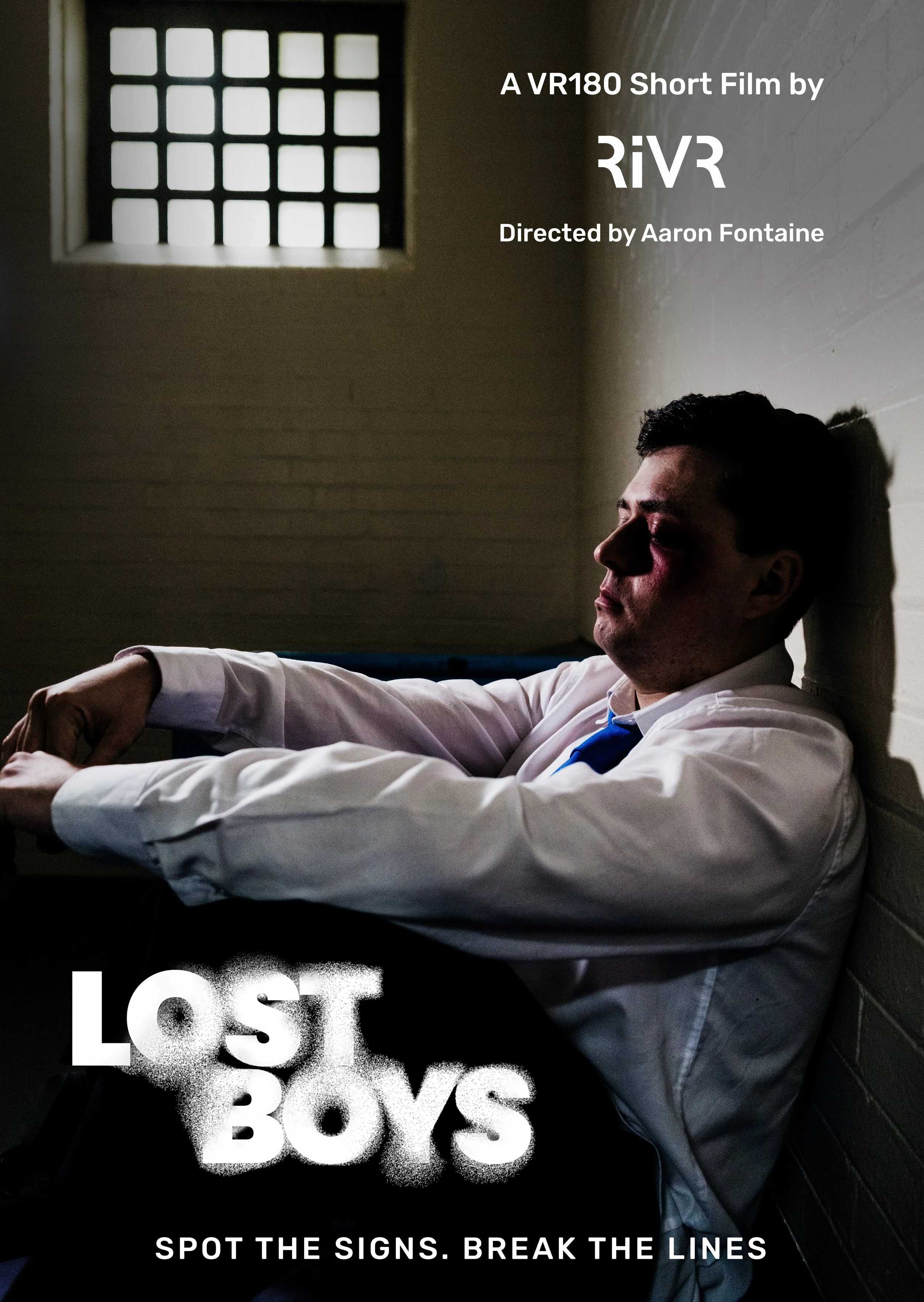 A man wearing a white shirt and a blue tie sitting on the floor against a wall with a window above him, with his eyes closed. The text over the image mentions a short film by RIVR, directed by Aaron Fontaine, with themes about loss and breaking the lines.