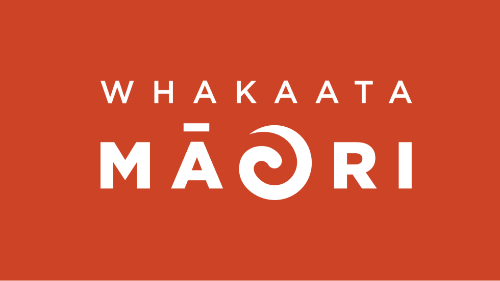 Red background with the words "WHAKAATA MAORI" printed in white, with Maori symbols incorporated into the text.
