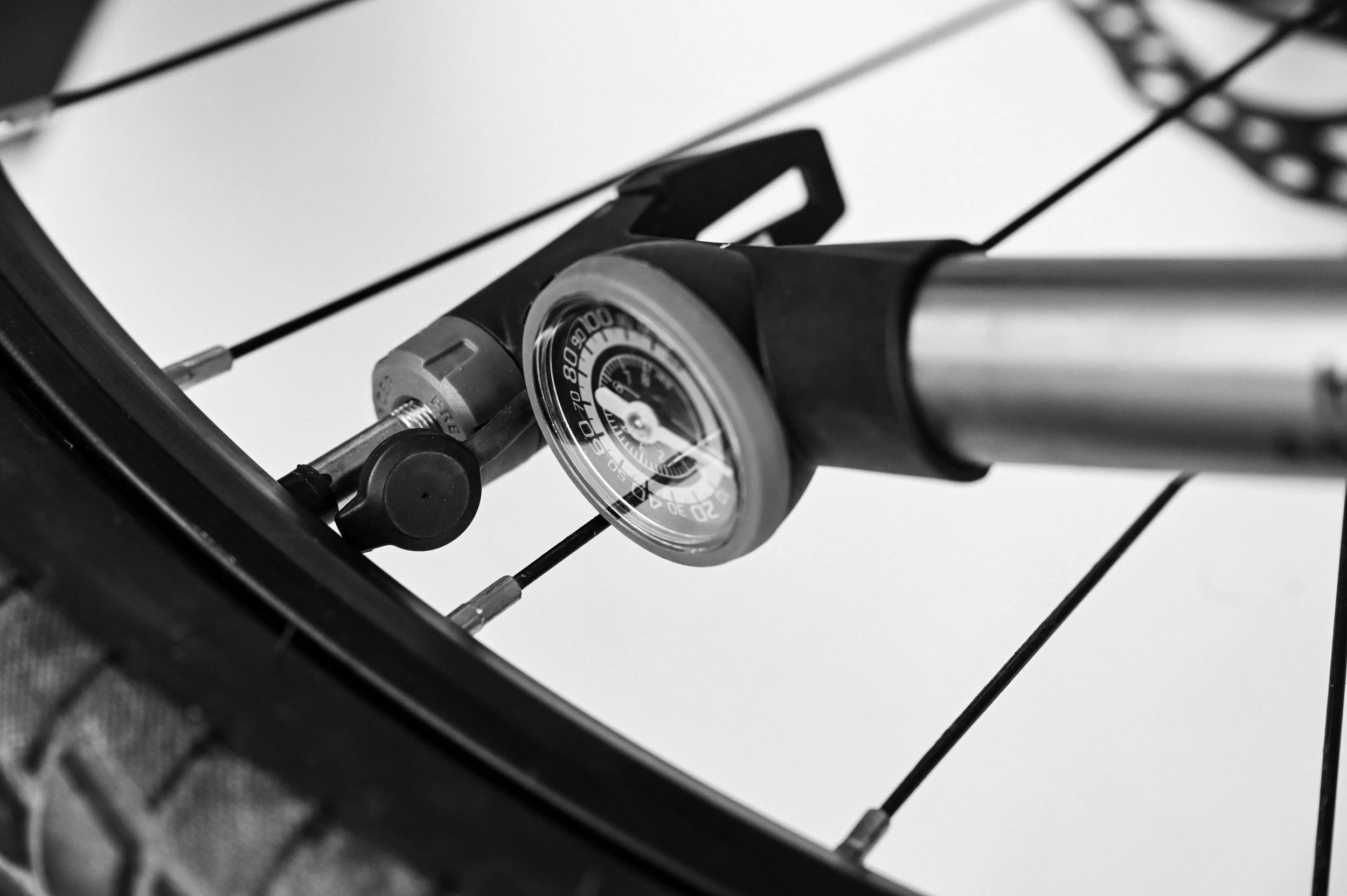 Close-up of a bicycle's gear and derailleur mechanism, black and white photograph.