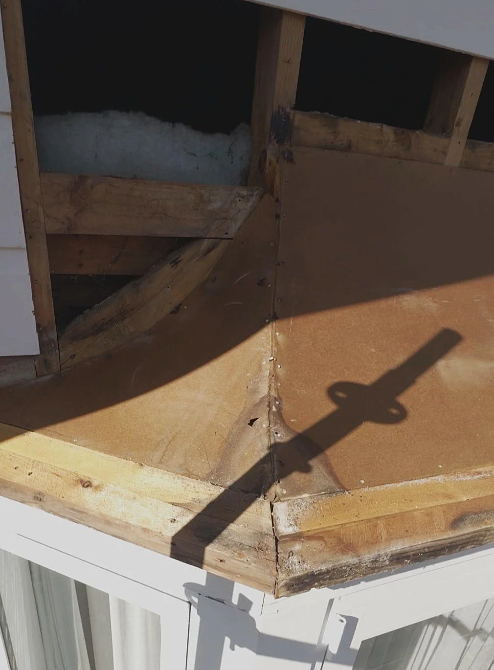 Rotten timber damage exposed above a bay window during repairs in Auckland