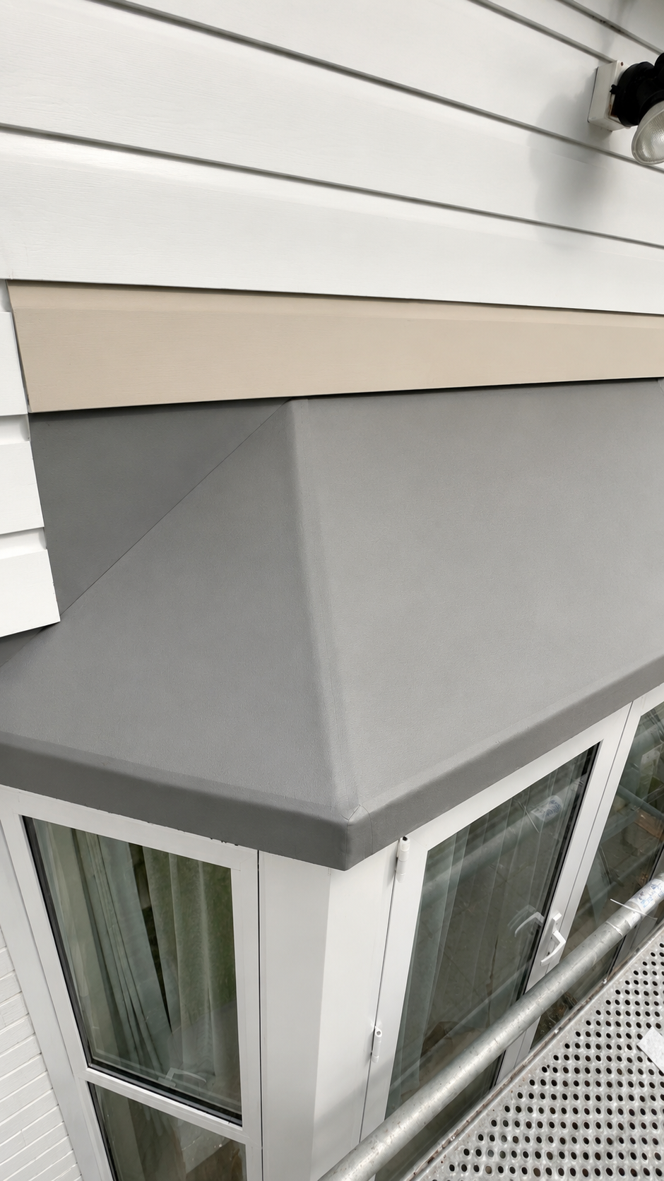Timber framing rebuilt above a bay window before exterior painting