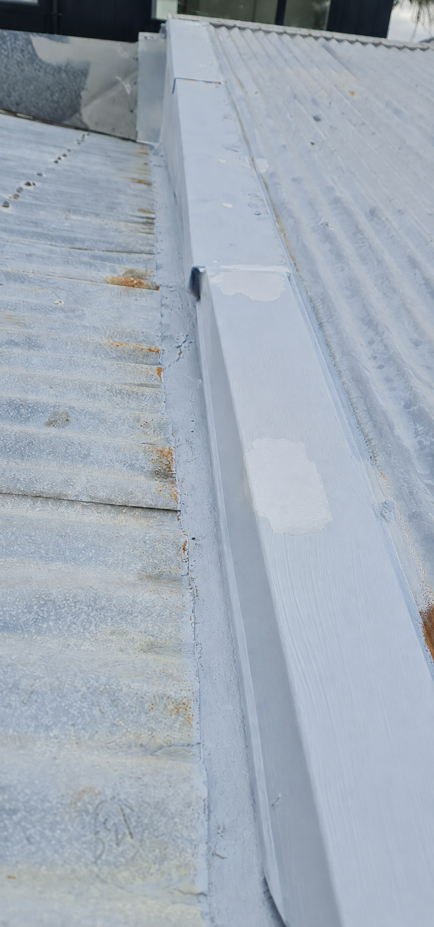 Rust treatment applied to metal roofing before roof painting in Auckland