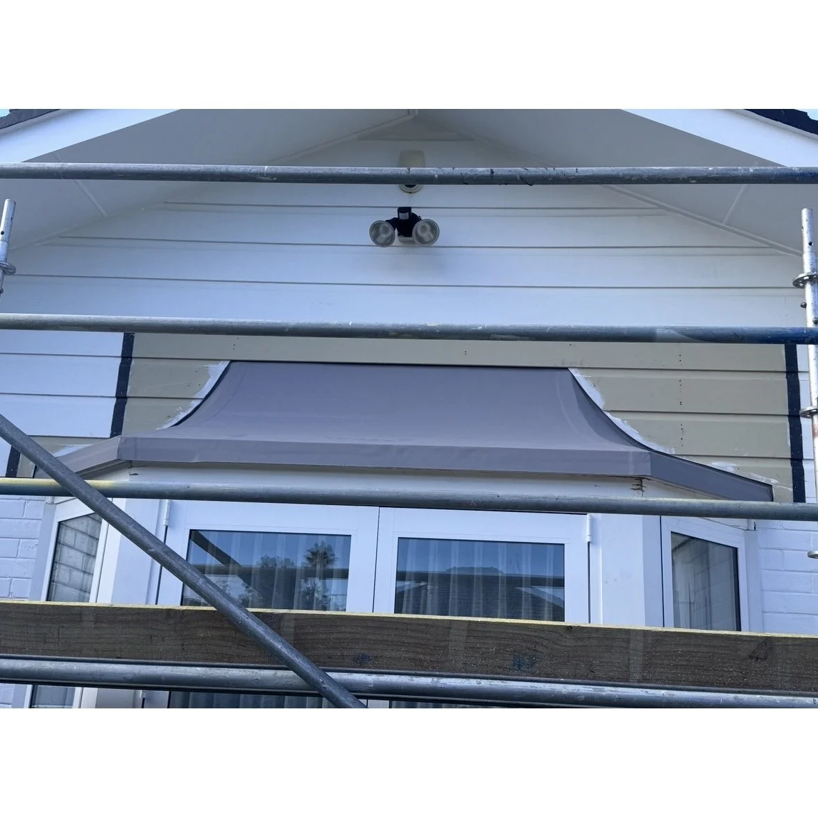 Repaired exterior timber and bay window area prepared for painting