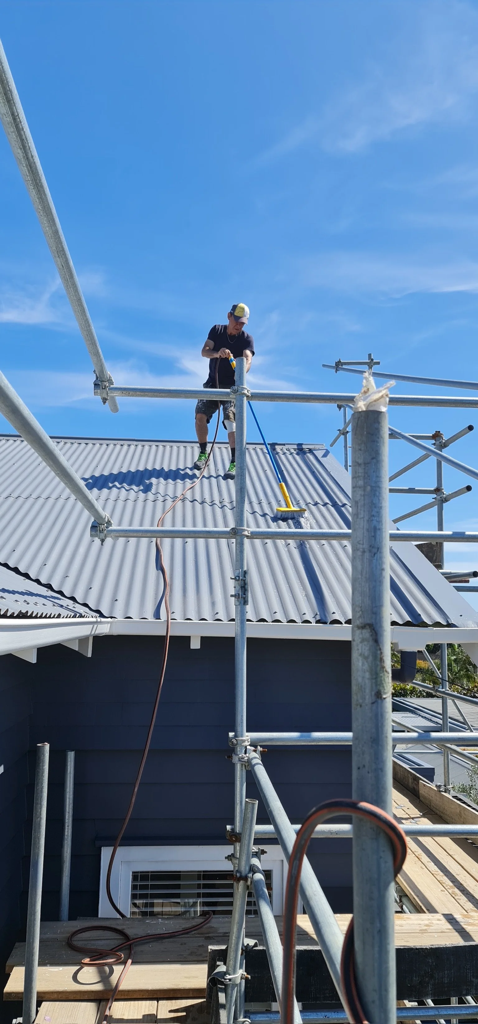 Freshly painted metal roofing with durable charcoal protective coating