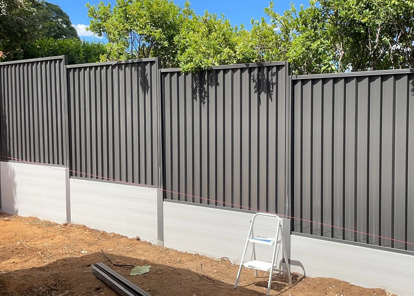 composite sleeper wall with timber fence on top built in merrimac