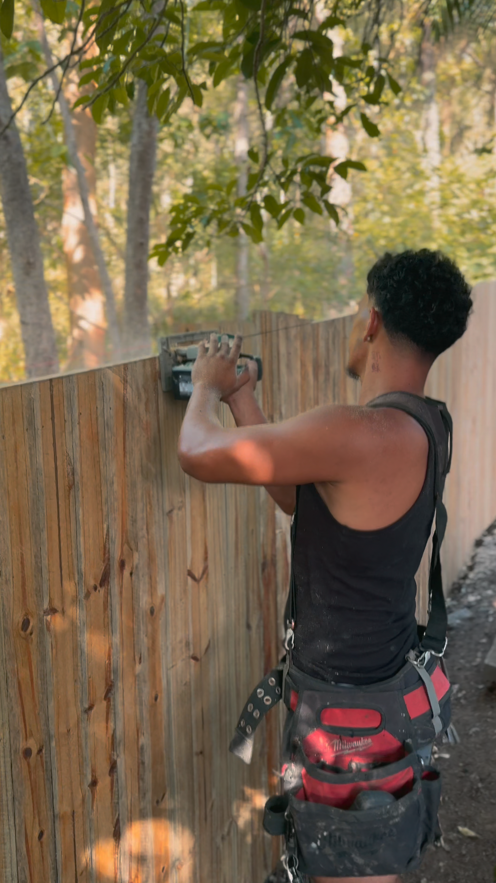 Crew on site at Pacific Pines building timber fence and timber gates