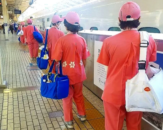 Shinkansen cleaning crew waiting to board train