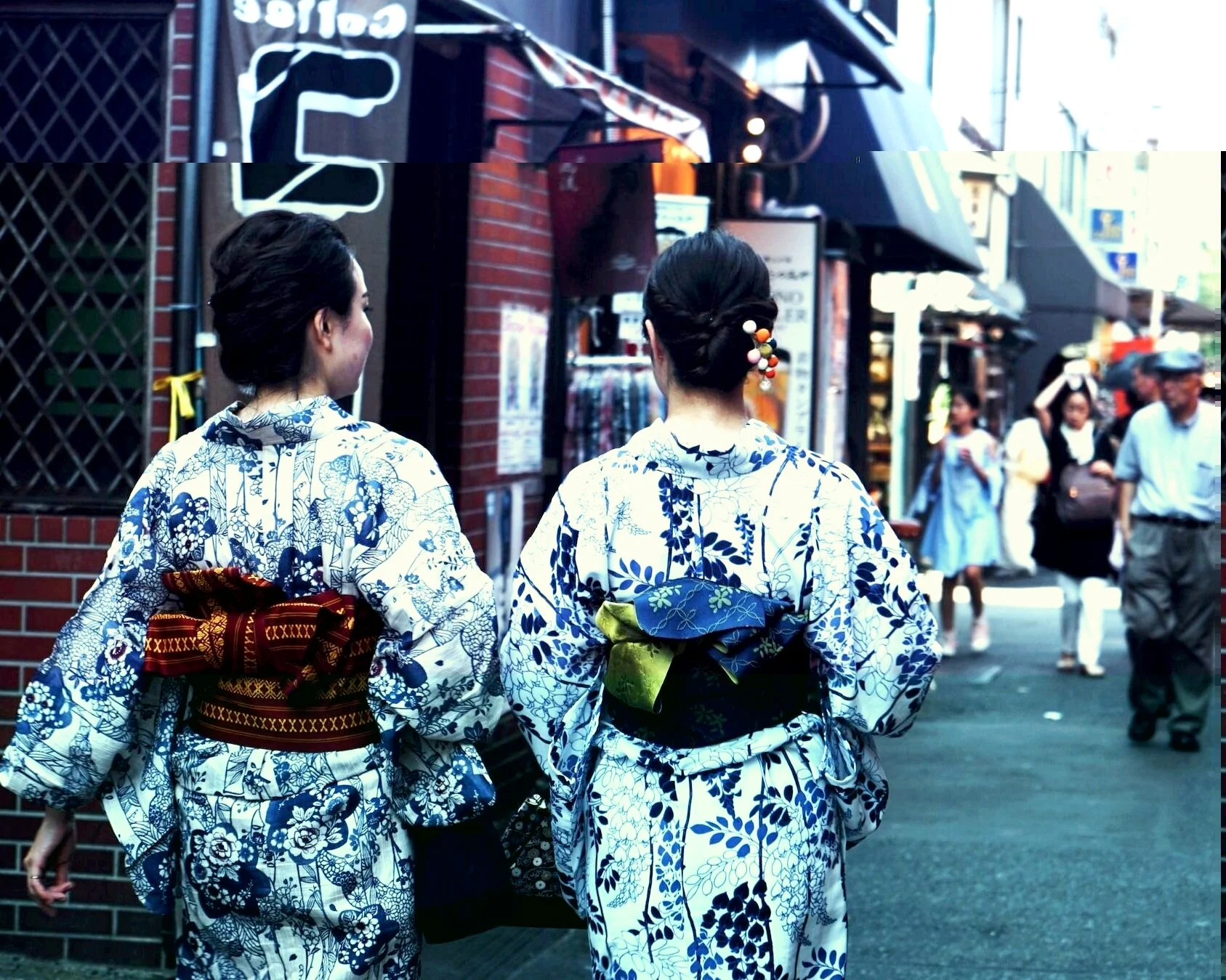 Kimono wearing women in walking down laneway