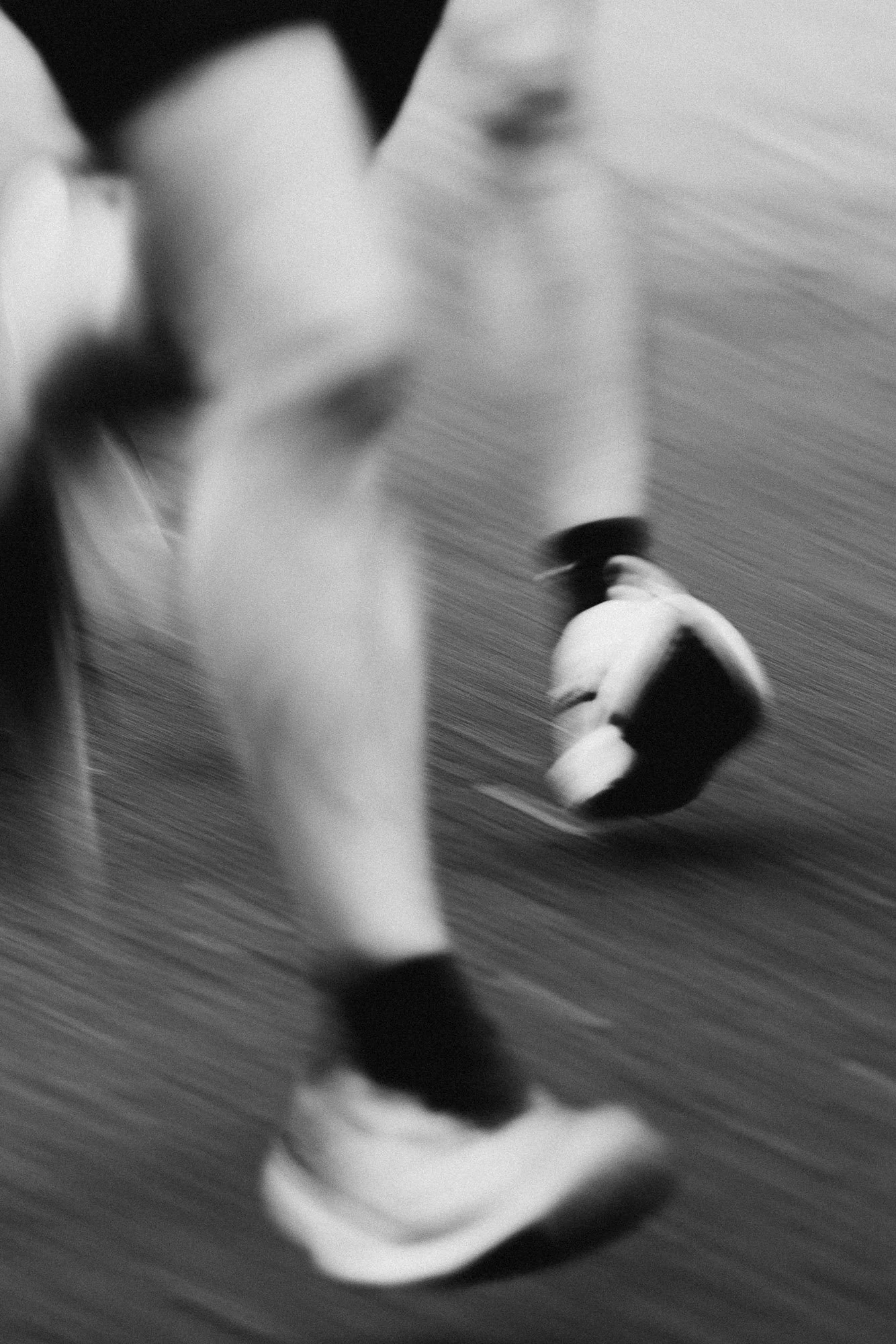 Blurry black and white photo of runners feet during a marathon