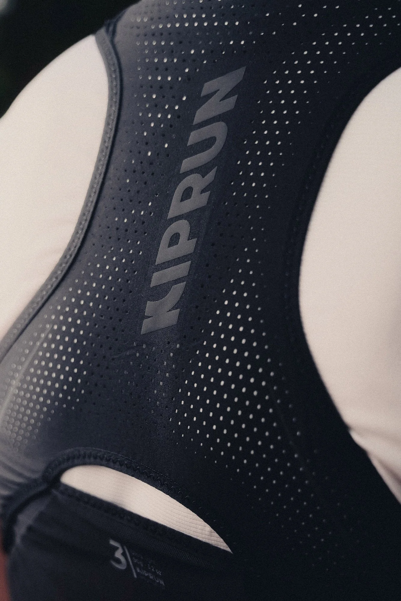 Close-up of a black Kiprun Running vest with the brand name "KIPRUN" visible on the upper part.