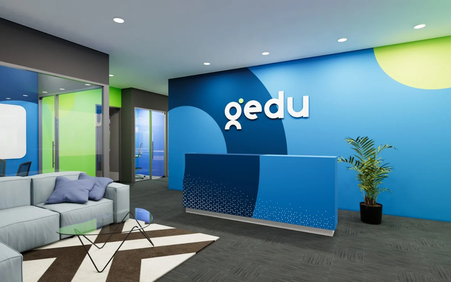Office reception area with blue and green walls, a white sofa with purple pillows, a small glass table, and a blue reception desk with a potted plant nearby. The wall behind the desk displays the text 'QEDU.'