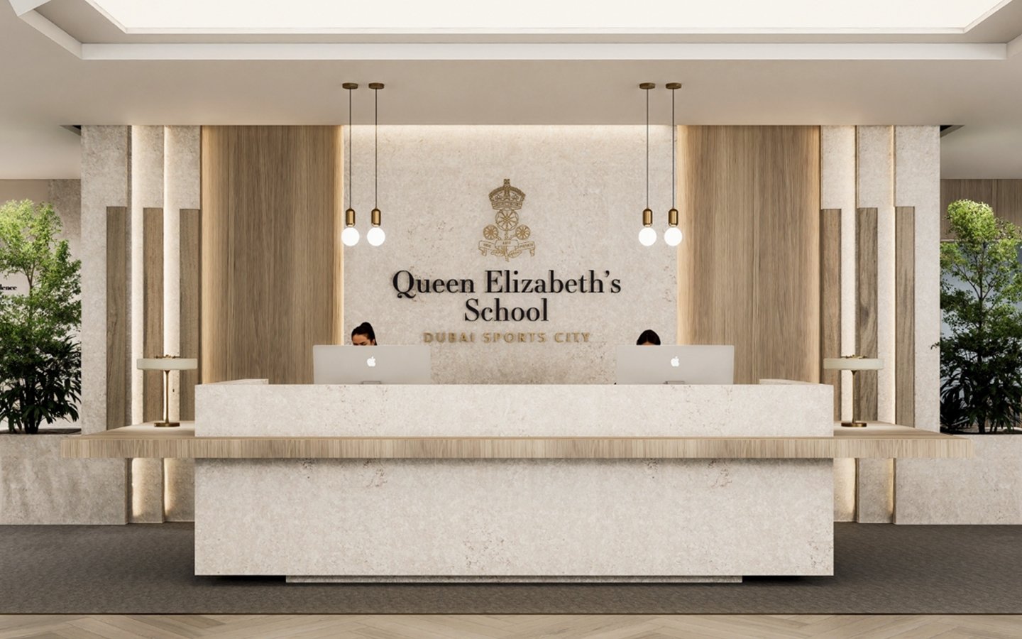 Reception desk at Queen Elizabeth's School in Dubai Sports City with two receptionists using Apple Mac computers, modern decor, and greenery on either side.