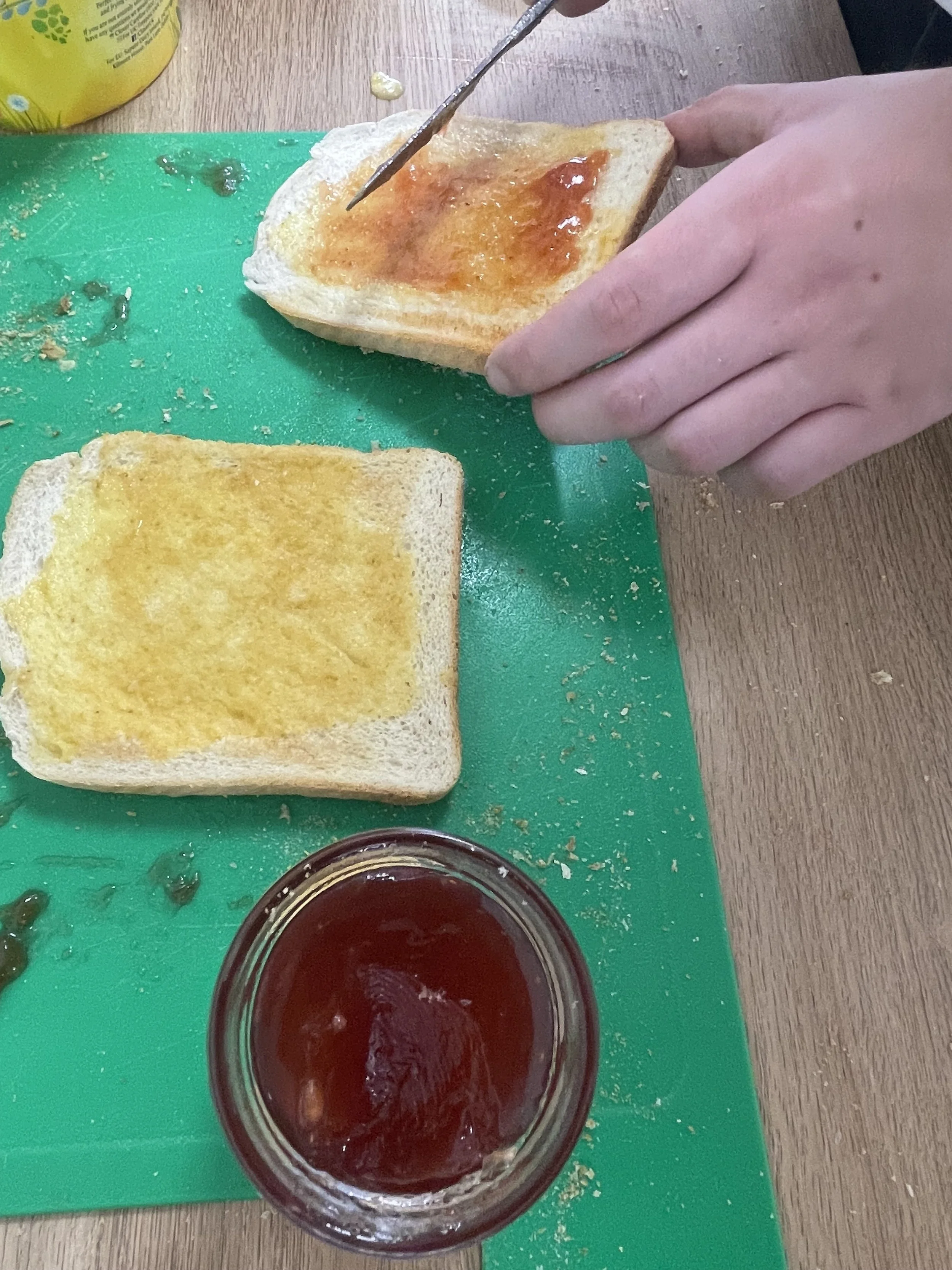 Jam is being spread on toast, ready for serving to Twenty 7 visitors.