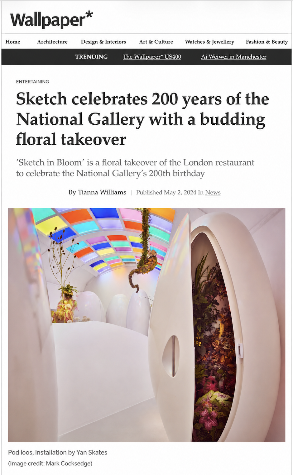Art installation of colorful stained glass ceiling and floral arrangements inside a white pod-shaped structure for a celebration of London's National Gallery 200th anniversary.