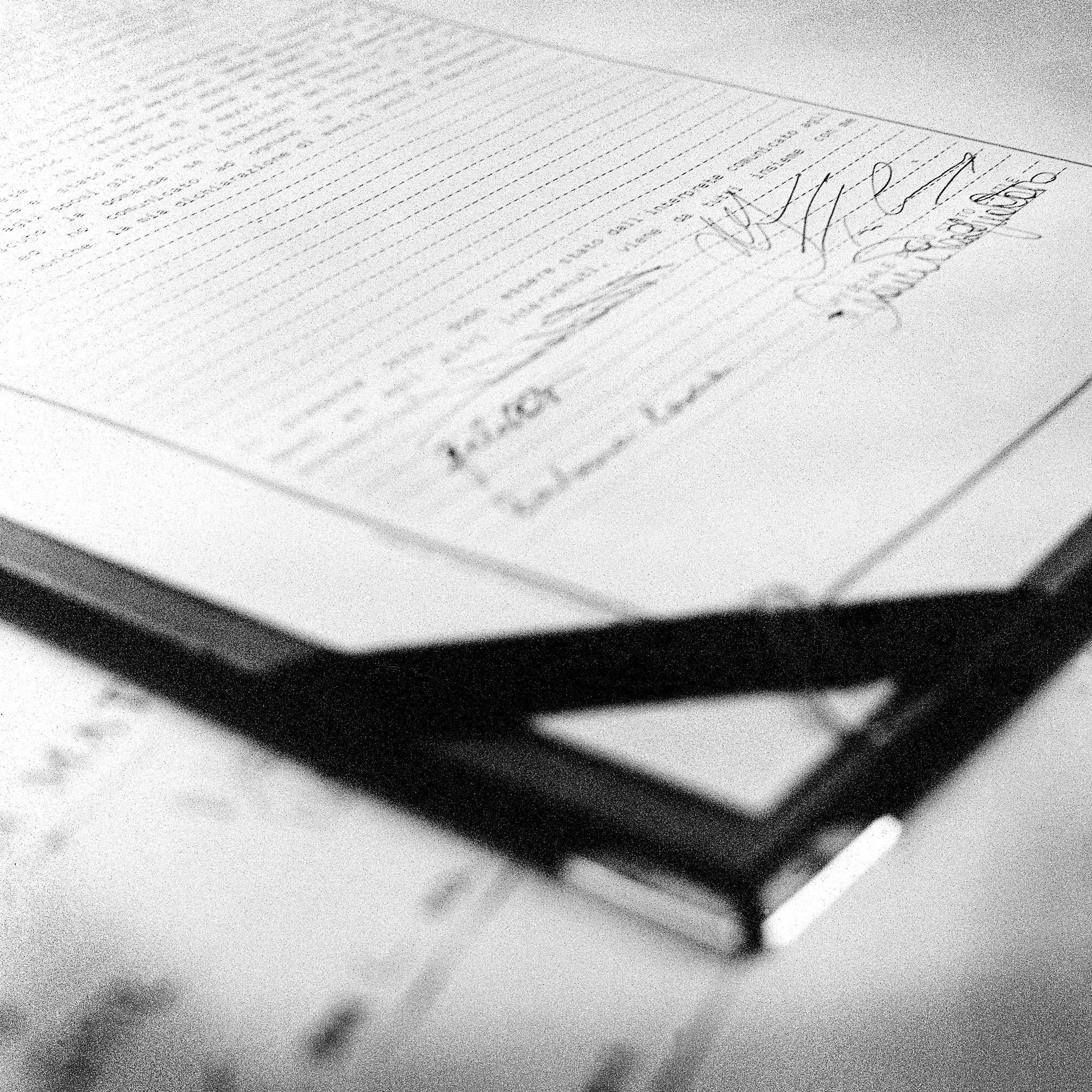 A close-up image of a handwritten letter or note on lined paper, with cursive writing and a signature at the bottom.