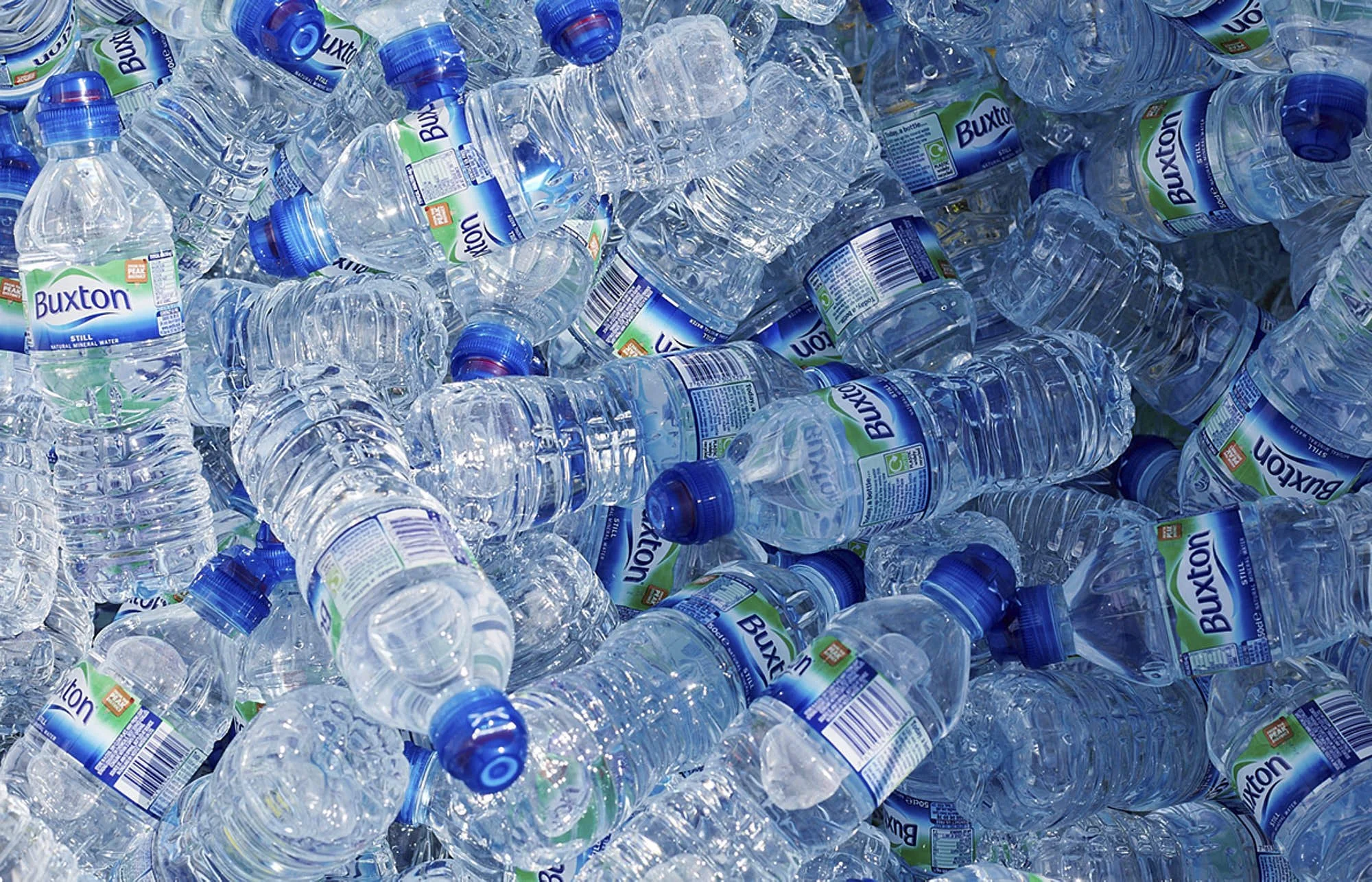 A large pile of crushed and empty Buxton bottled water containers.