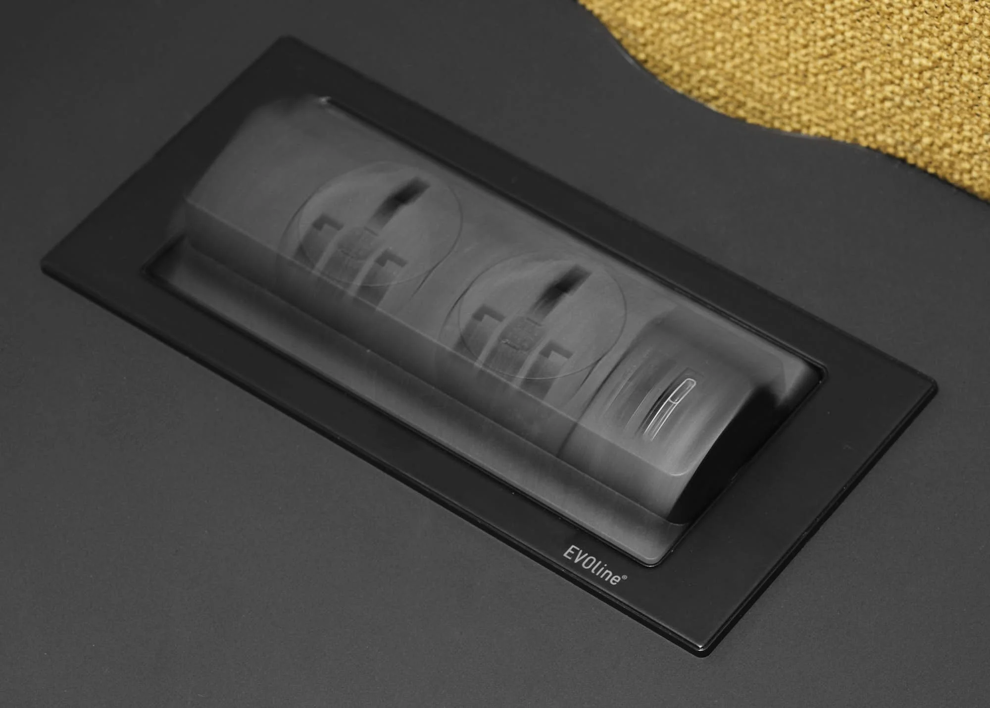 Close-up of a digital kitchen scale on a black surface, with a yellow textured object partially visible in the top right corner.