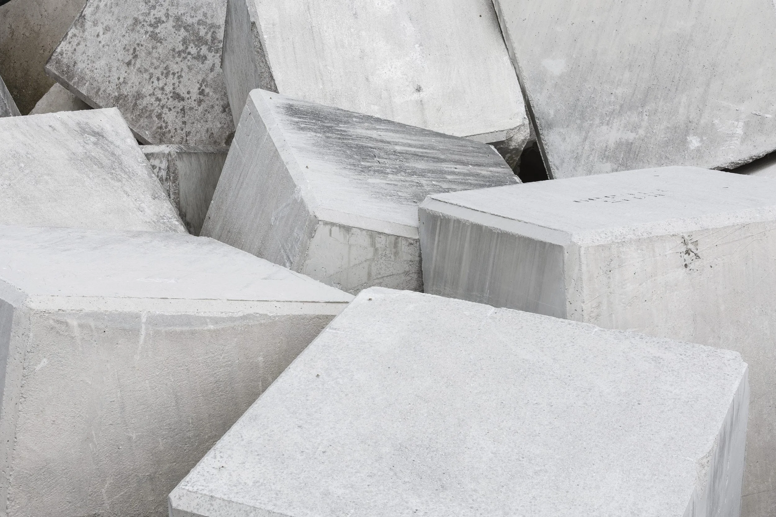 Large concrete blocks stacked together, suggesting capital built up over time.