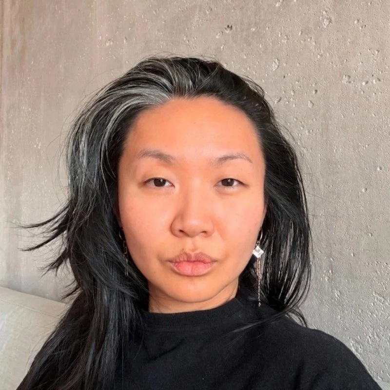 A woman with long black hair.