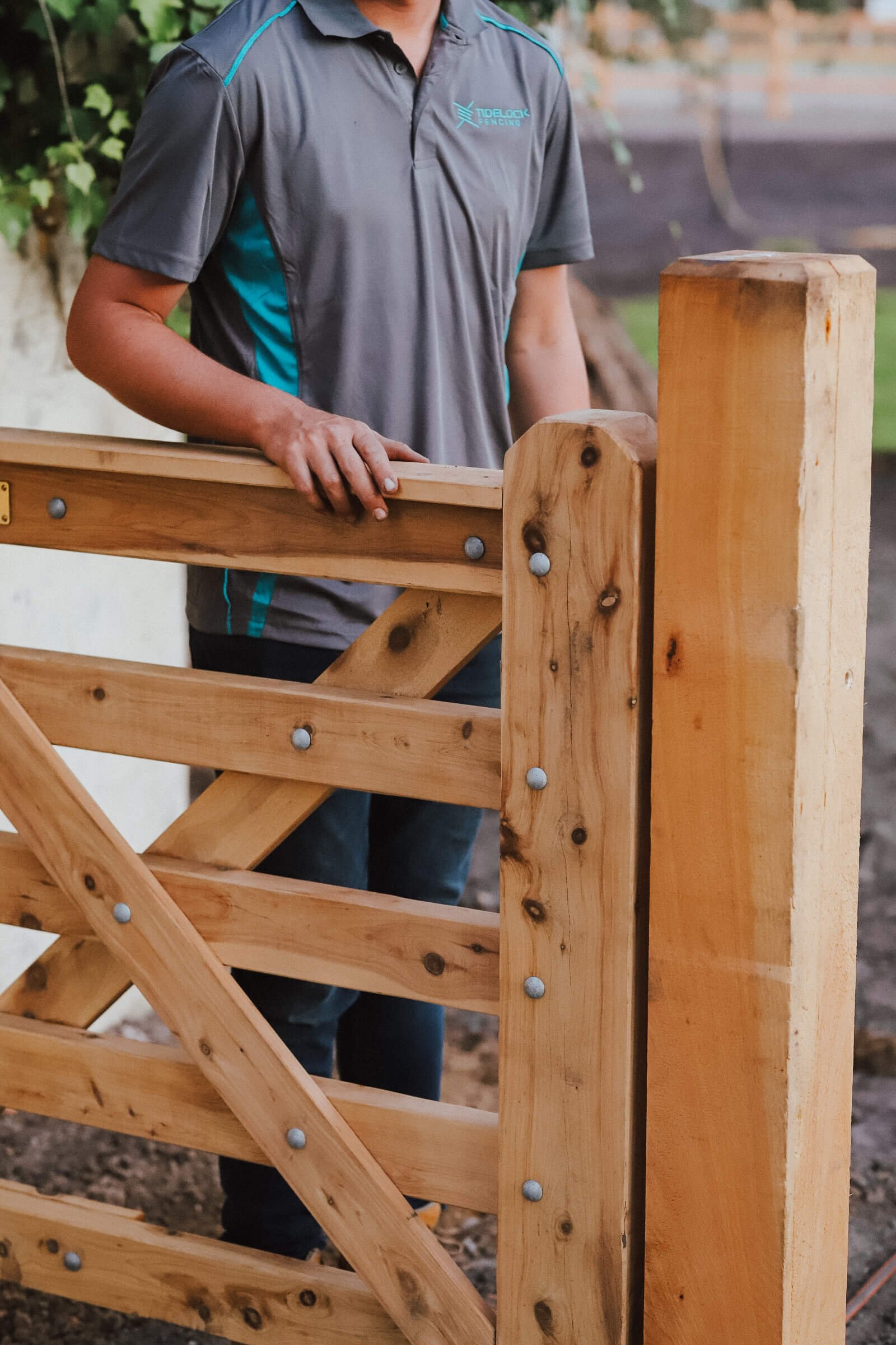 Manwearingtidelockfencinggreypoloshirtfencemaintenance.jpg