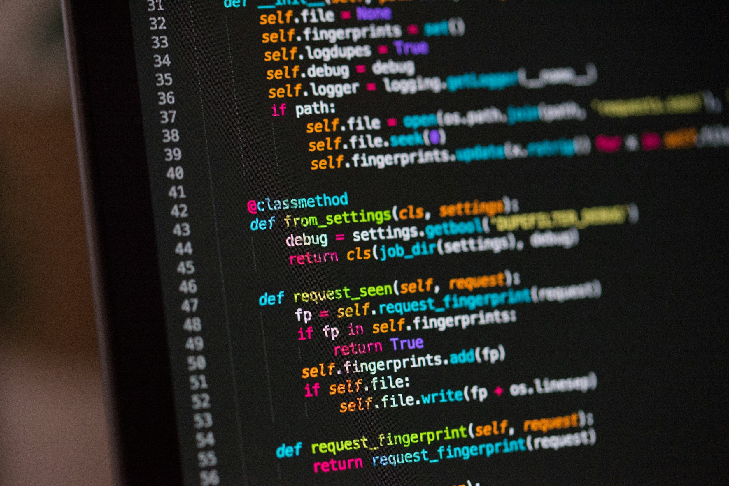 Close-up photo of a computer screen displaying colorful Python source code.