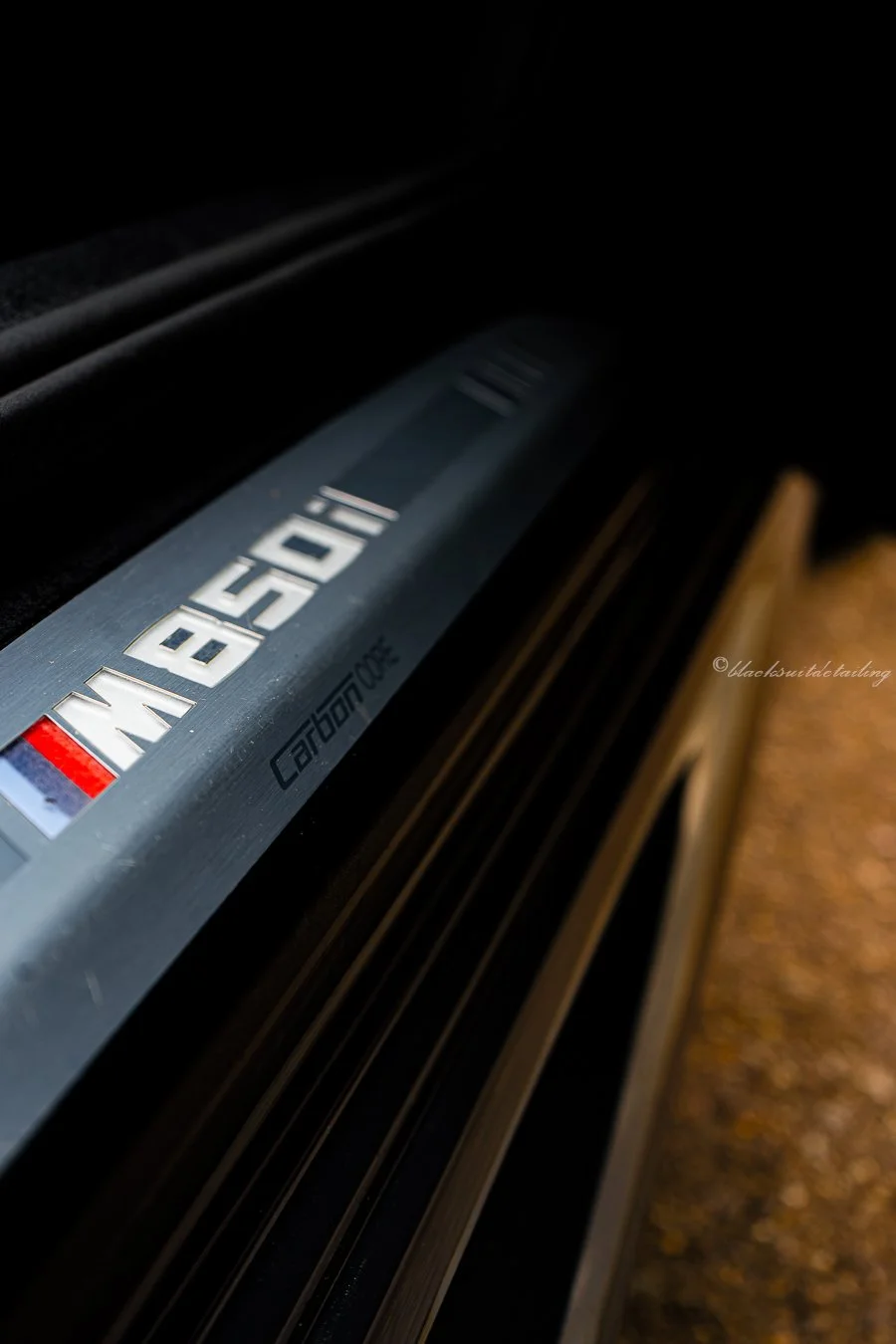 Close-up of a silver Bentley car door sill plate with Bentley logo and branding, part of a vehicle interior or exterior detail shot.