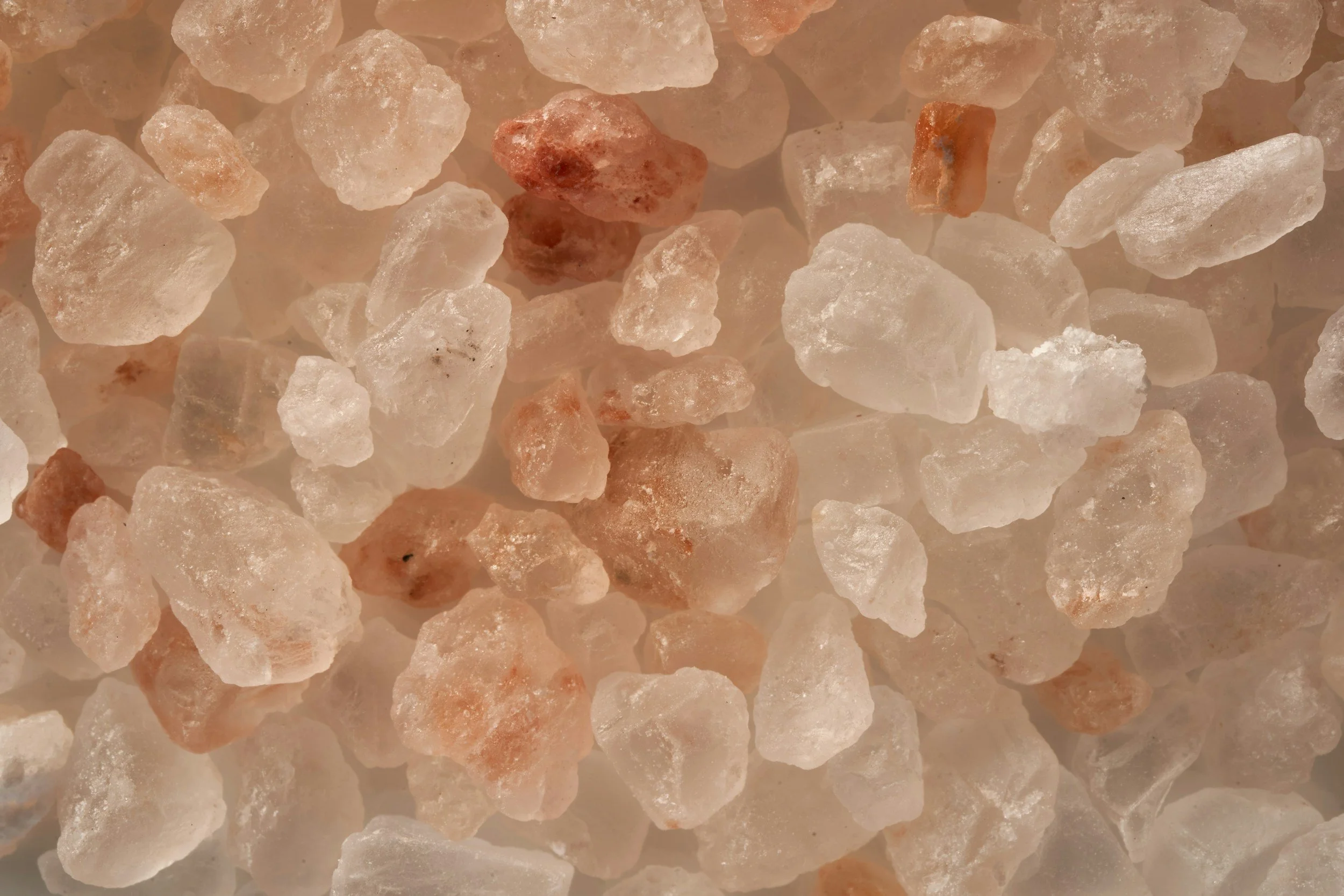 Close-up of coarse pink Himalayan salt crystals.