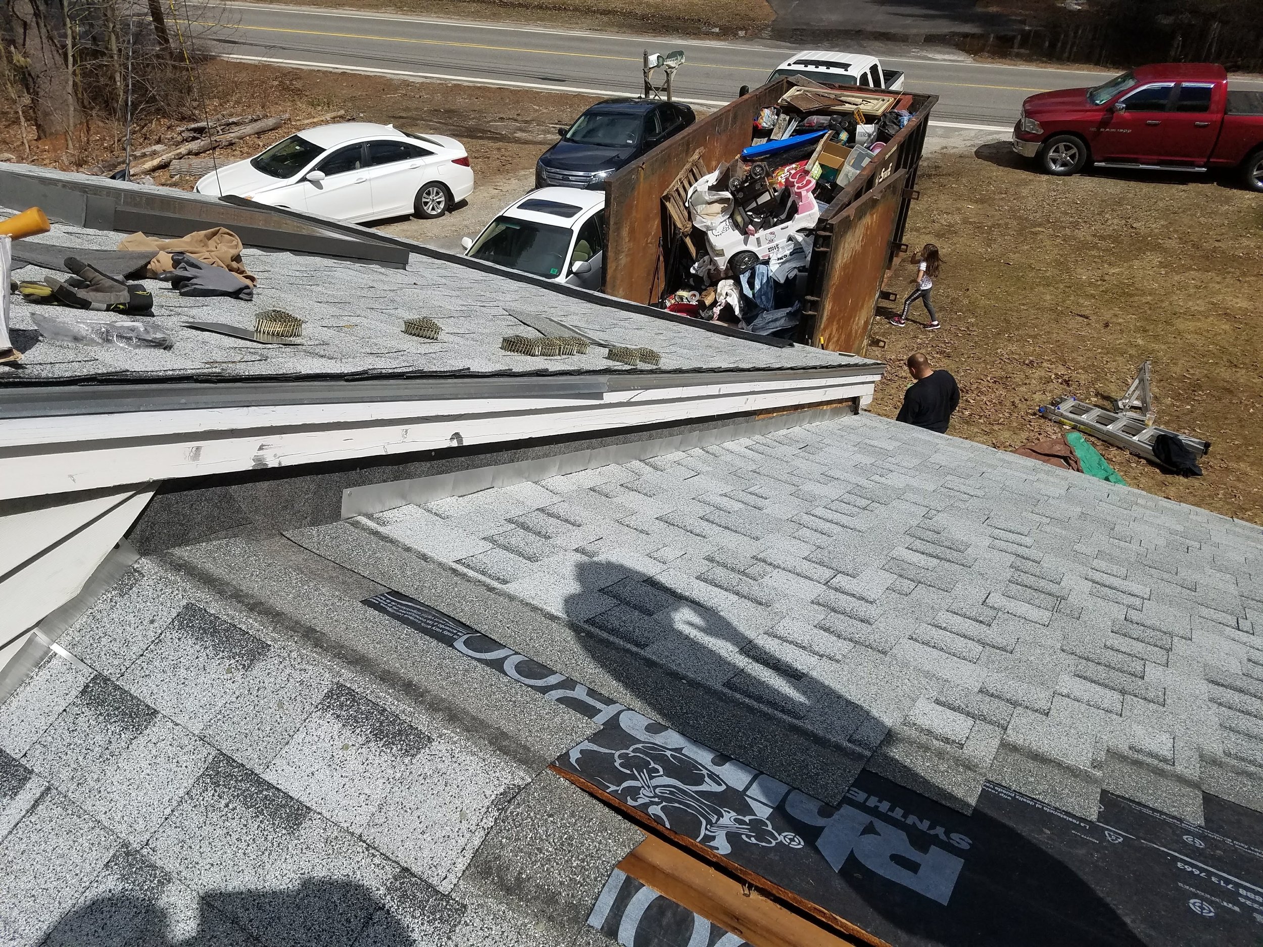 Roof flashing installation with professional roofing tools and construction materials during a roof replacement project.