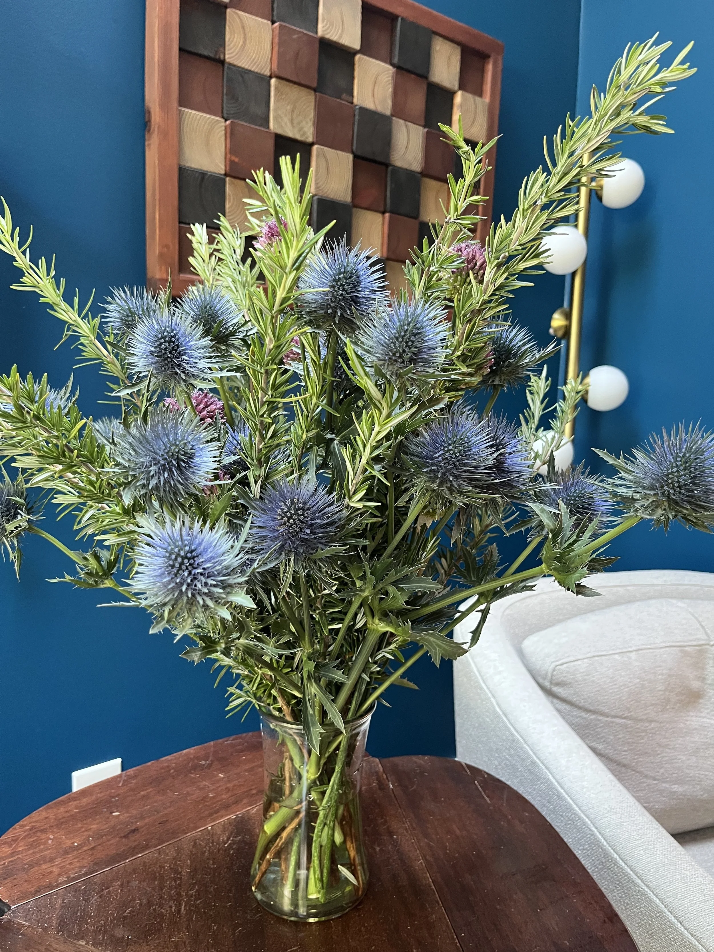 A bouquet of flowers in a glass vase on a table.