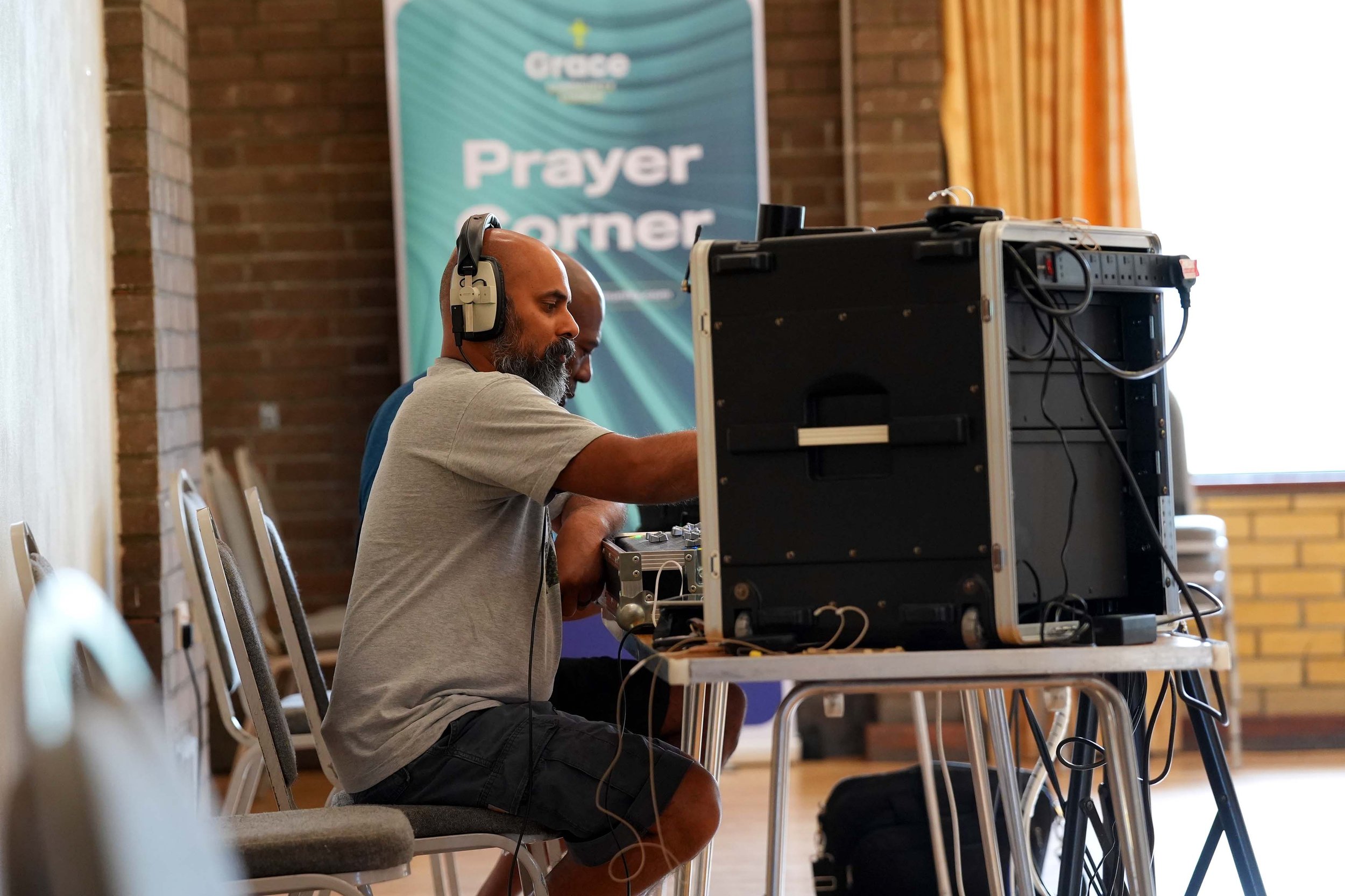 A volunteers mans the sound desk at the Addison Centre for a Grace Sunday Service